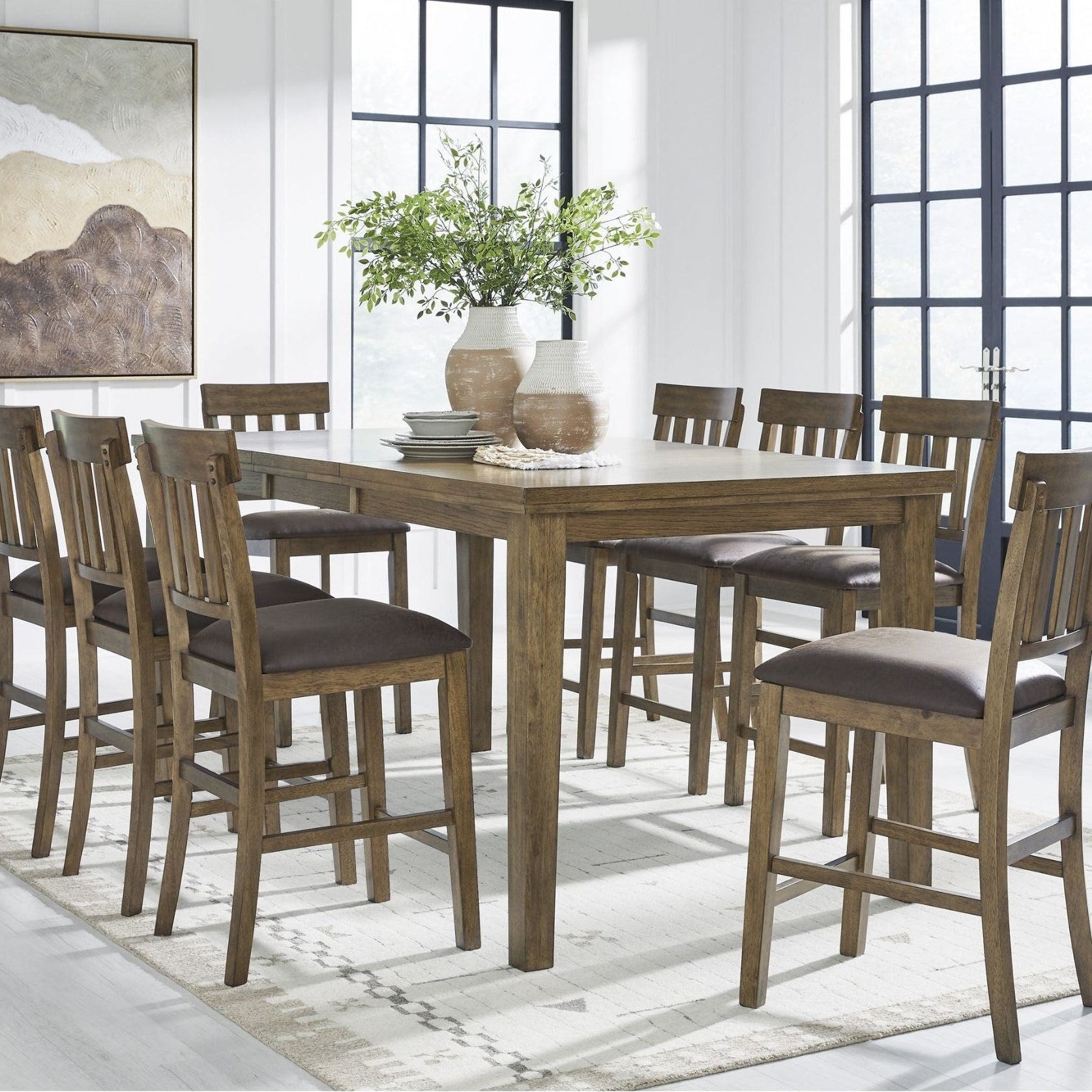 Ashley Urbinforte 9-piece counter height dining set with light brown wood finish, featuring a spacious table and matching chairs.