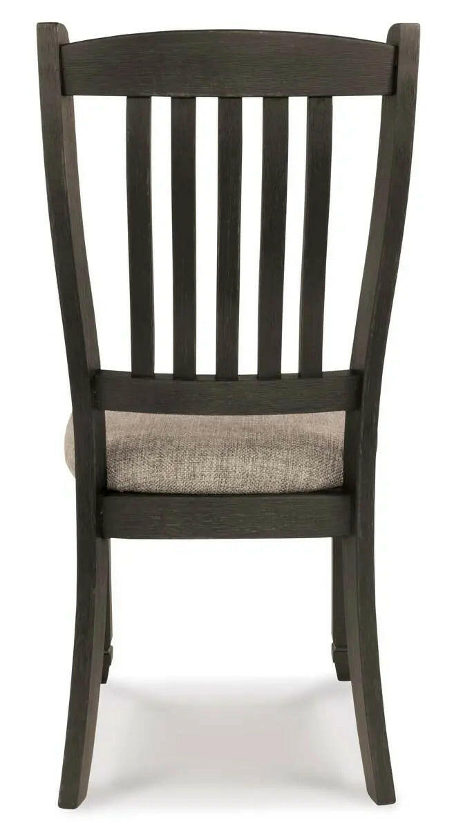 Back view of the Tyler Creek two-tone Ashley dining room set with arm chairs, showcasing the elegant design and wood finish.