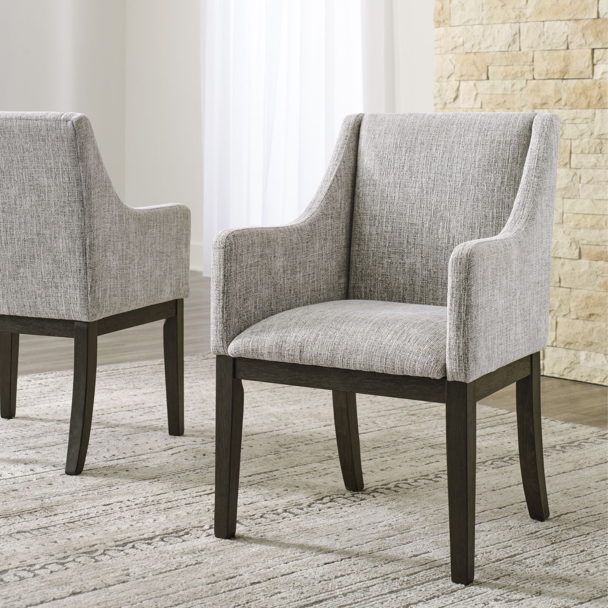 Set of two Signature Ashley Burkhaus Dining UPH Arm Chairs with upholstered seats and wooden legs, modern dining room style