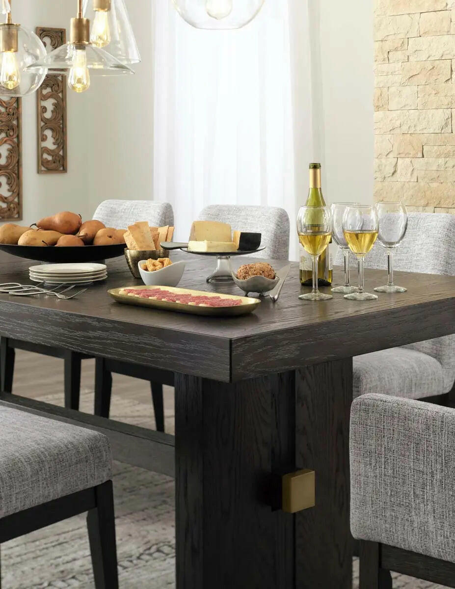 Dark brown Ashley Signature dining room set with an extendable table and armchair, detailed close-up of the tabletop and chair upholstery.