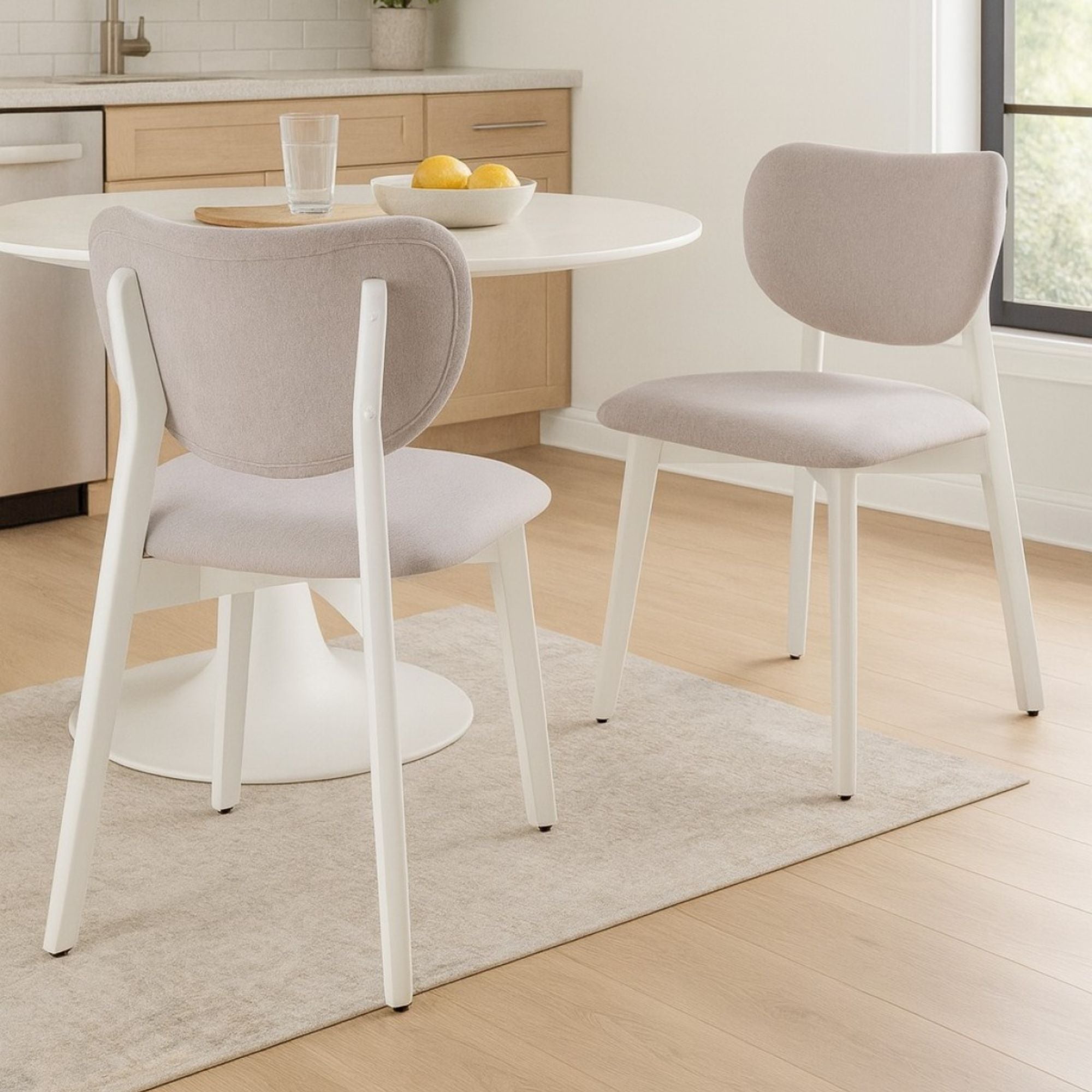 Pair of Durana dining chairs from Brassex, featuring modern design with wooden legs and upholstered seats.