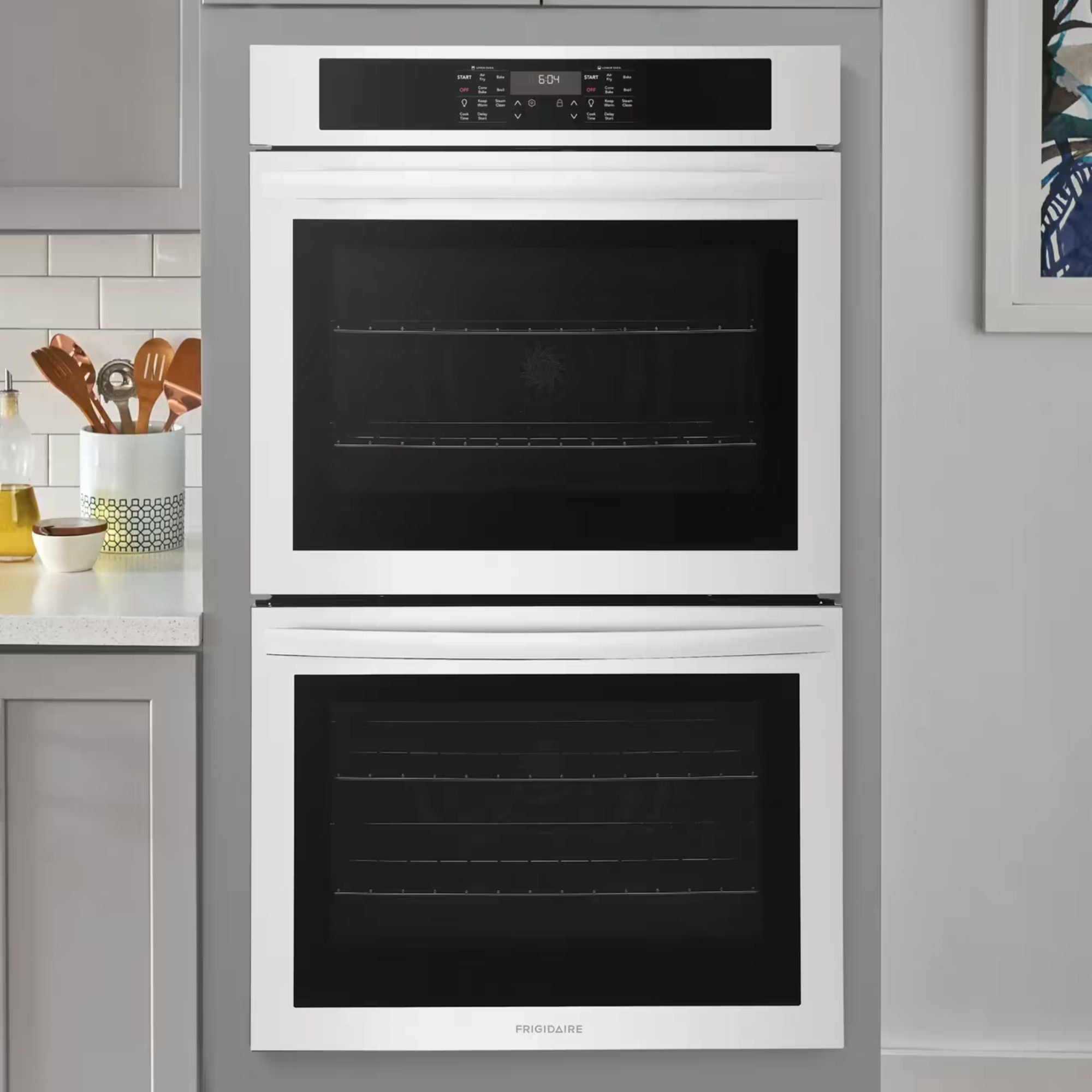 Frigidaire 30-inch double wall oven with air fry feature in white, showing control panel and oven doors.