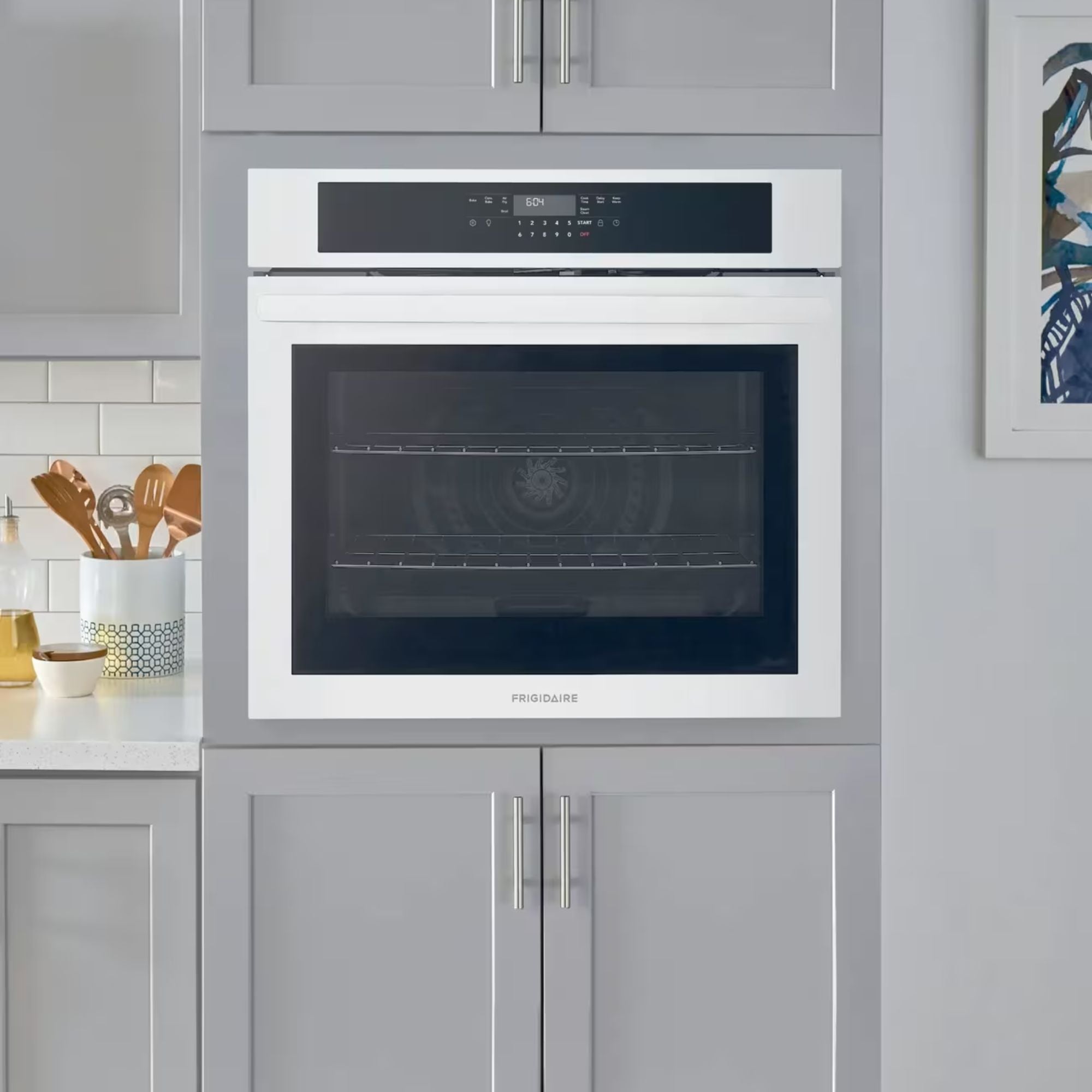 Frigidaire FCWS3030AW 30-inch white single wall oven with air fry feature, shown installed in a modern kitchen.