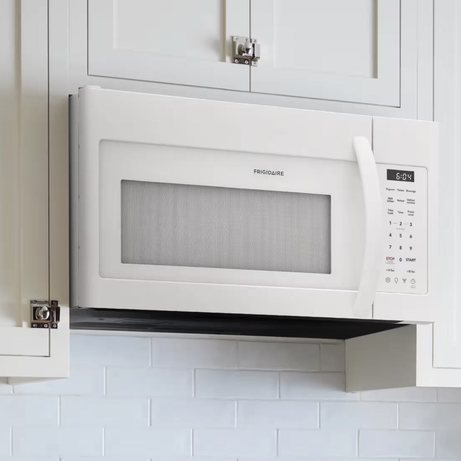 White Frigidaire FMOS1846BW over-the-range microwave with digital control panel and spacious 1.8 cu. ft. interior.