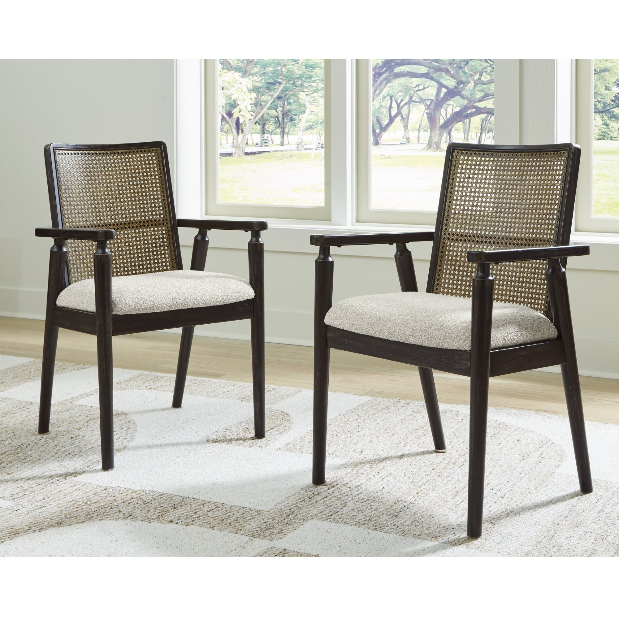 Set of two Galliden dining arm chairs by Signature Ashley with upholstered seats and wooden legs, modern and comfortable dining room furniture.