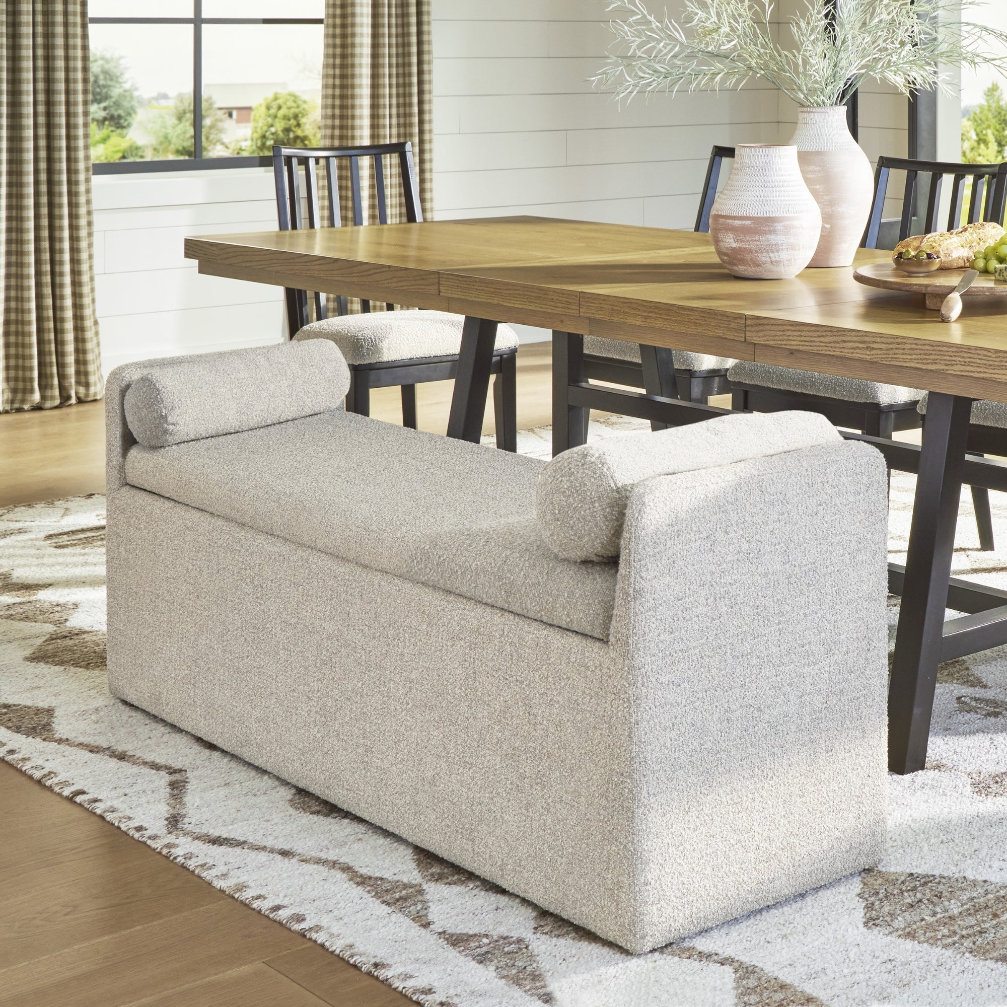 Ashley Galliden EXT dining room set with a large table and matching bench, showcasing wood finish and modern design.