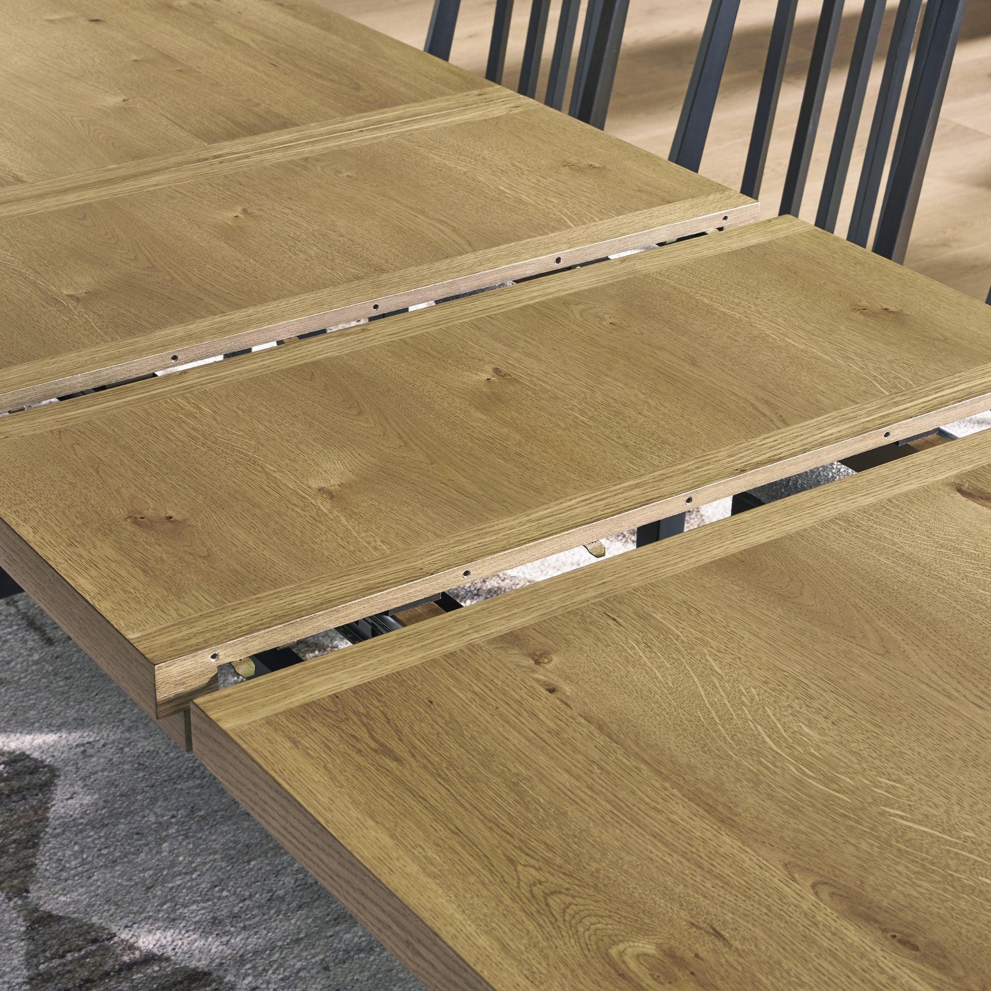 Modern Galliden EXT dining table by Signature Ashley with a sleek wooden surface and extendable design for kitchen and dining rooms.