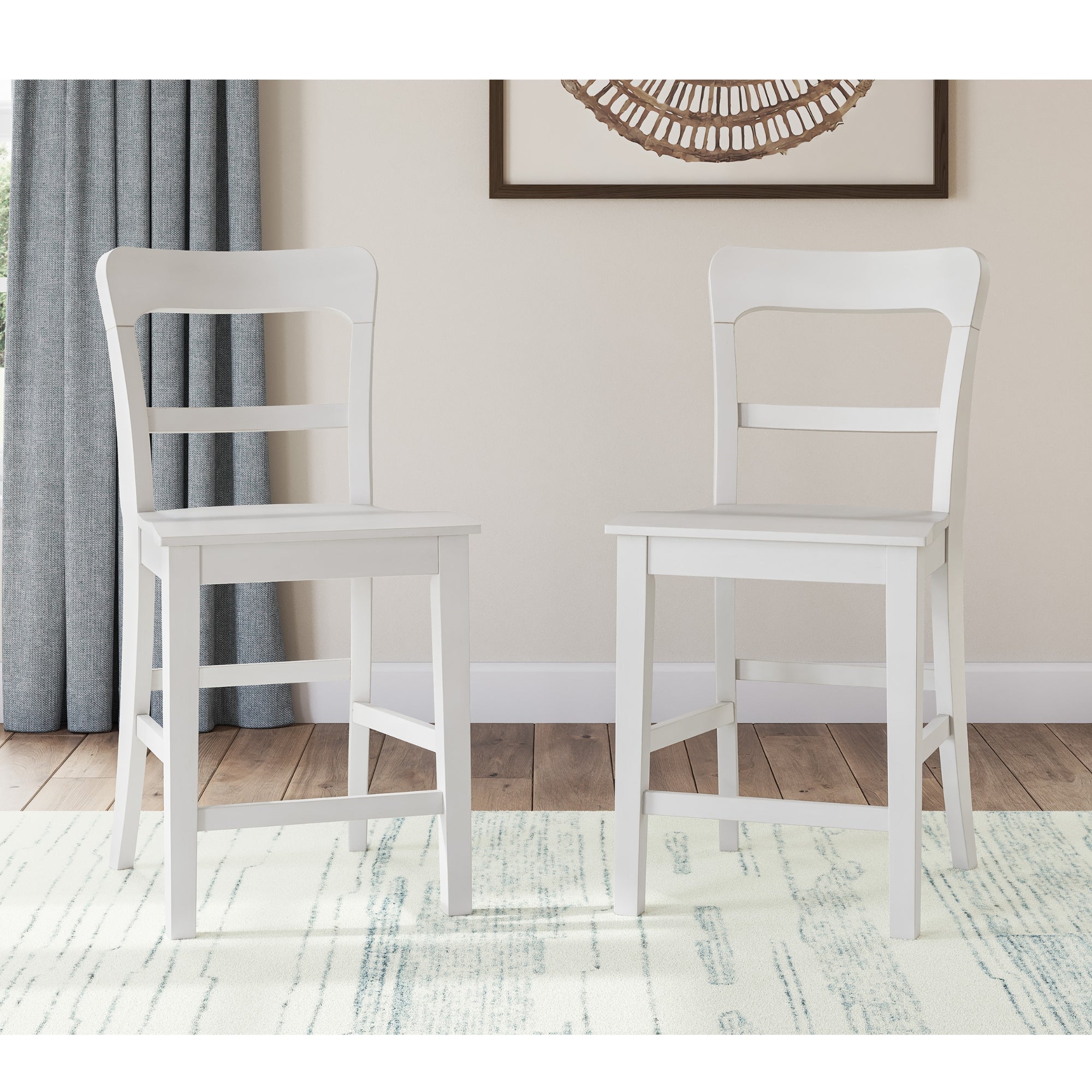 Two white Greddinton bar stools by Signature Ashley with wooden legs, shown from a side angle on a modern kitchen counter.