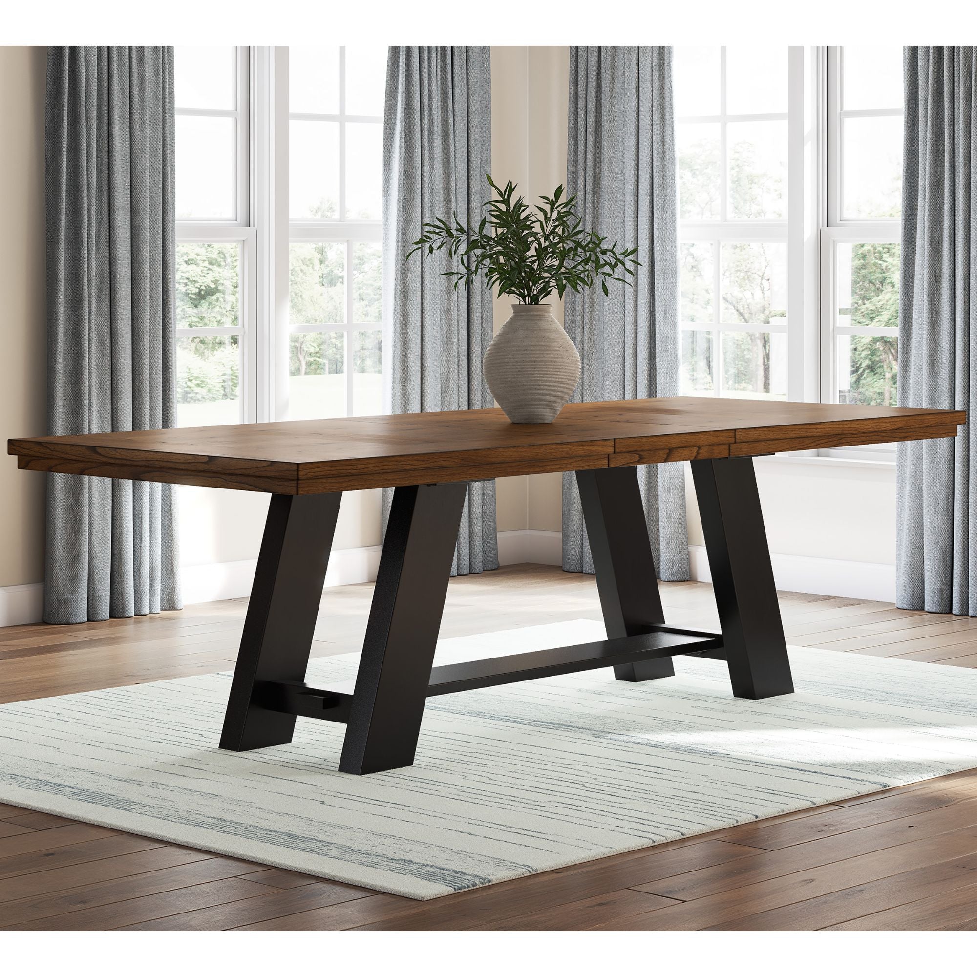Signature Ashley Greddinton Extension Dining Table shown in a modern dining room setting with wood finish and extended leafs.