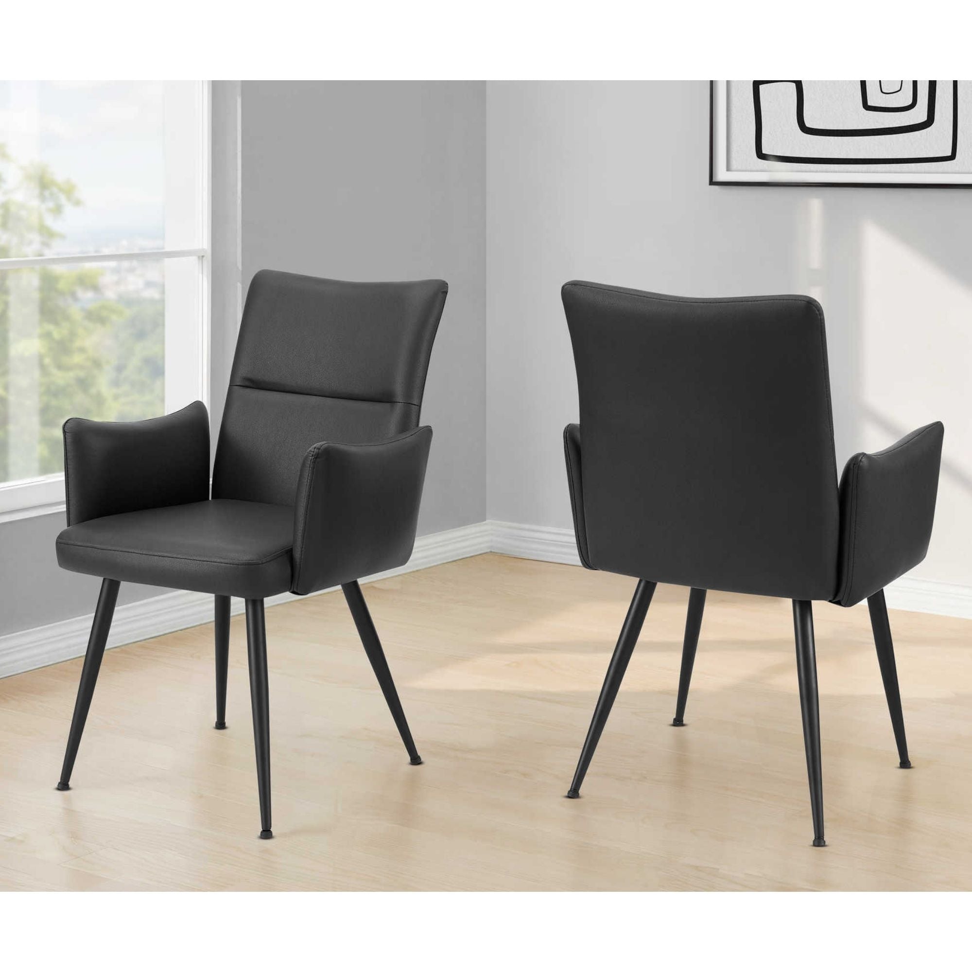 Pair of black leather-look dining chairs with metal legs from Monarch Specialties, showcasing modern, stylish seating for dining rooms.