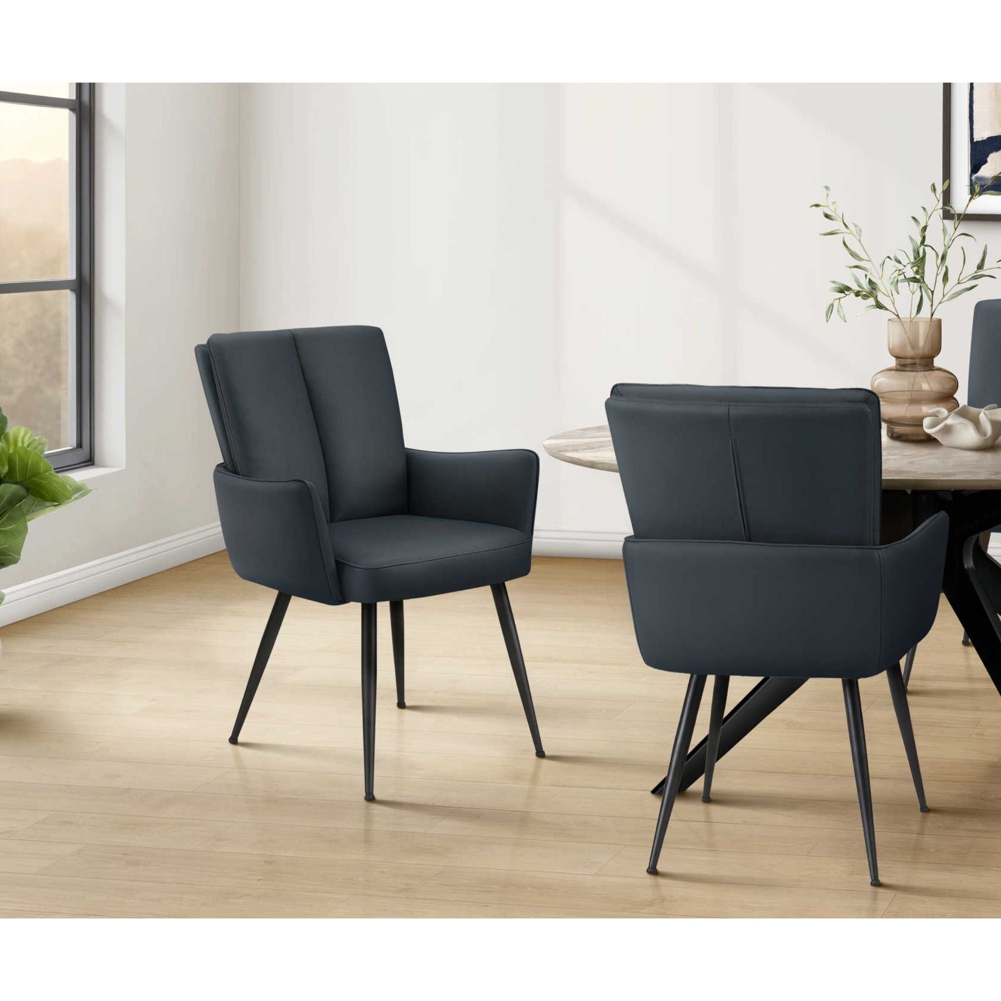 Pair of blue leather-look dining chairs with black metal legs from Monarch Specialties, featuring modern design and comfortable seating.