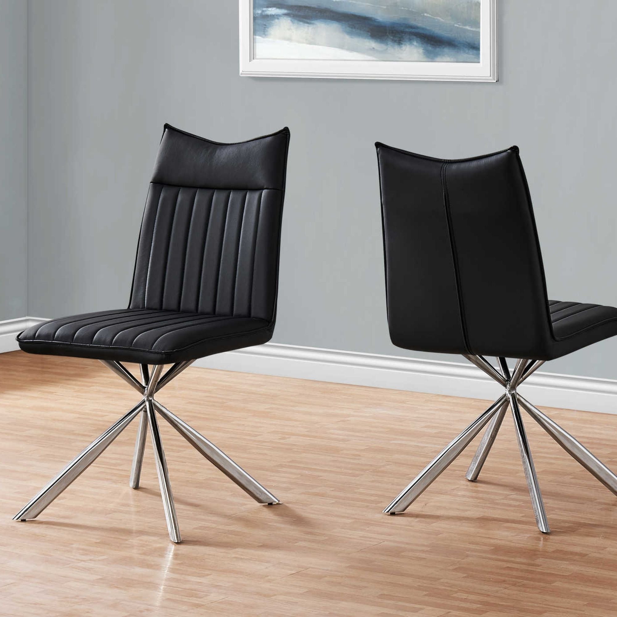 Pair of black leather-look dining chairs with chrome starburst bases by Monarch Specialties, showcasing modern seating for dining room.