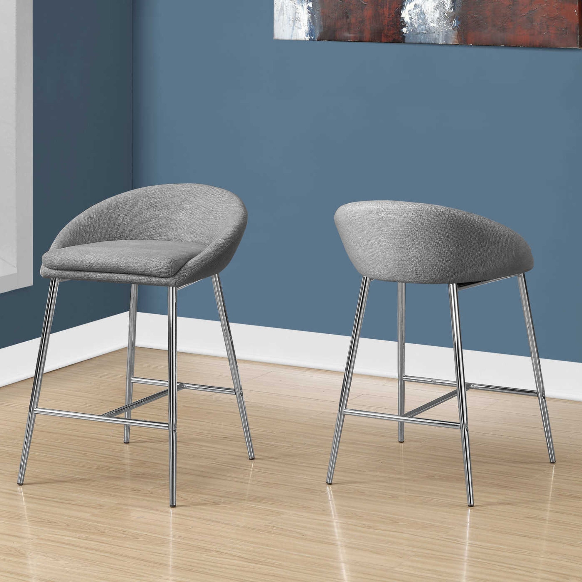 Set of two Luna Grey Monarch Specialties counter height bar stools with sleek design and wooden legs, perfect for modern kitchen counters.
