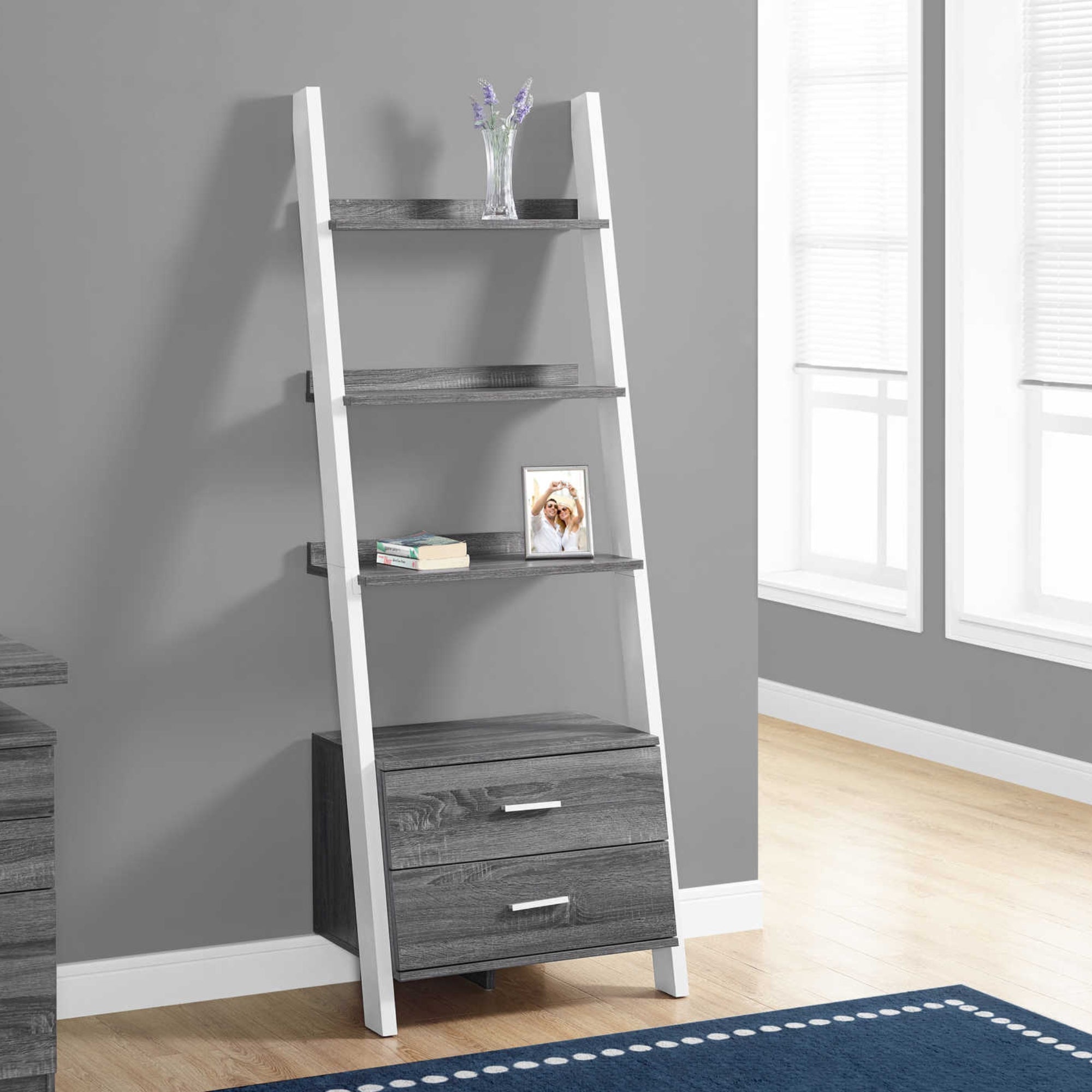 Grey ladder bookcase from Monarch Specialties with 2 storage drawers and open shelves for books and decor.