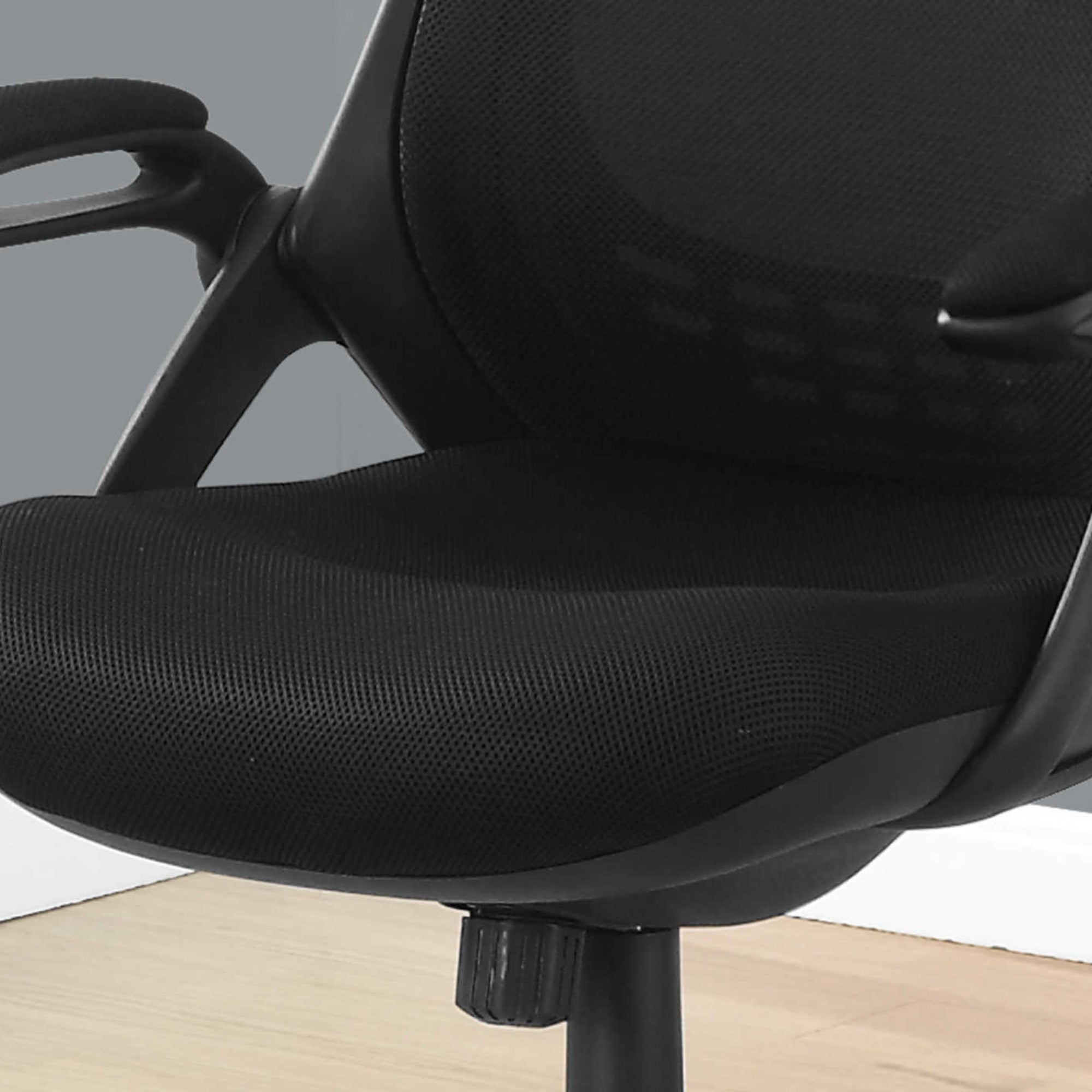 Black Monarch Specialties executive high-back mesh office chair with padded armrests and ergonomic design.