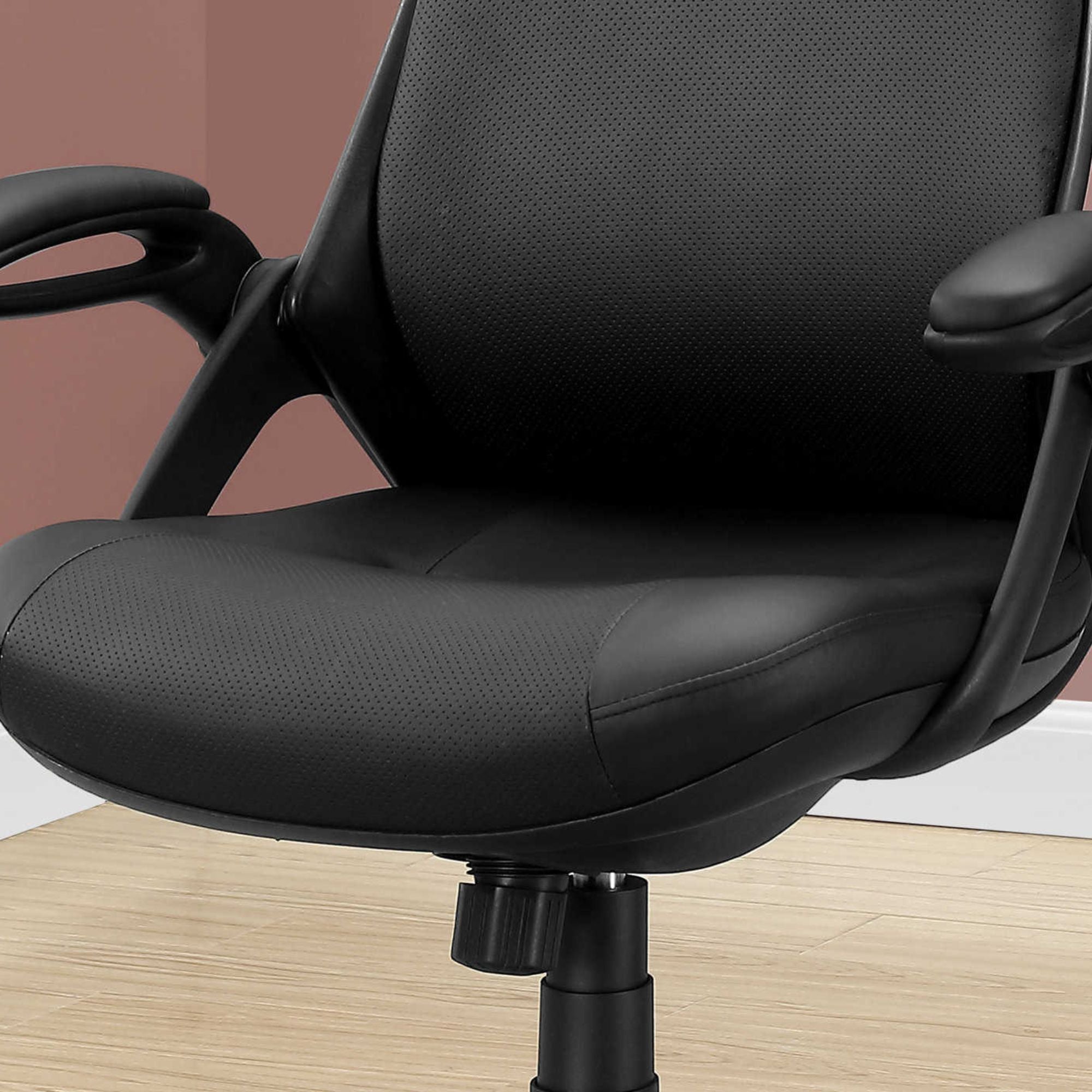 Black Monarch Specialties executive high-back leatherlook office chair with padded armrests and adjustable height.
