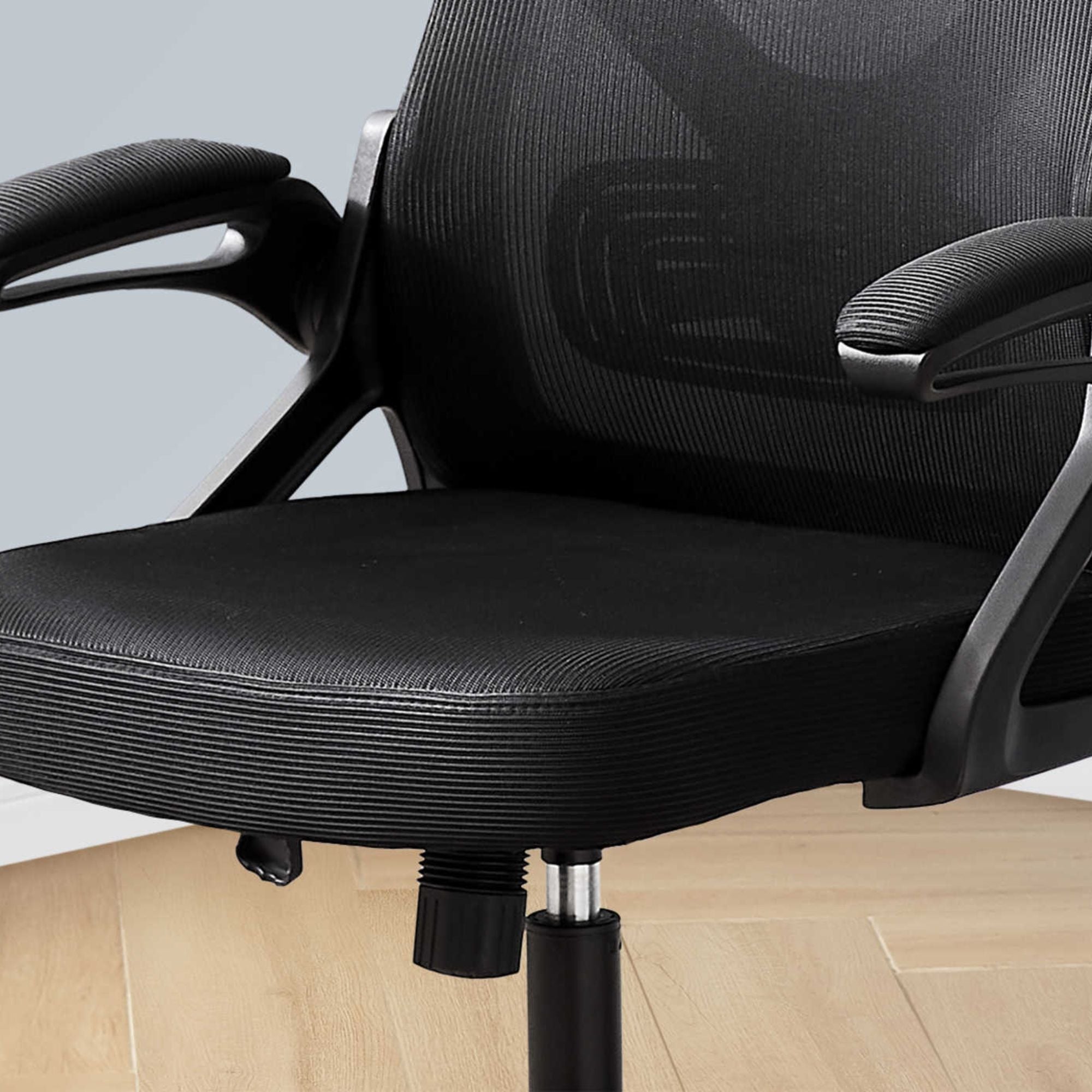 Black mesh Postura office chair by Monarch Specialties featuring ergonomic design and adjustable features.