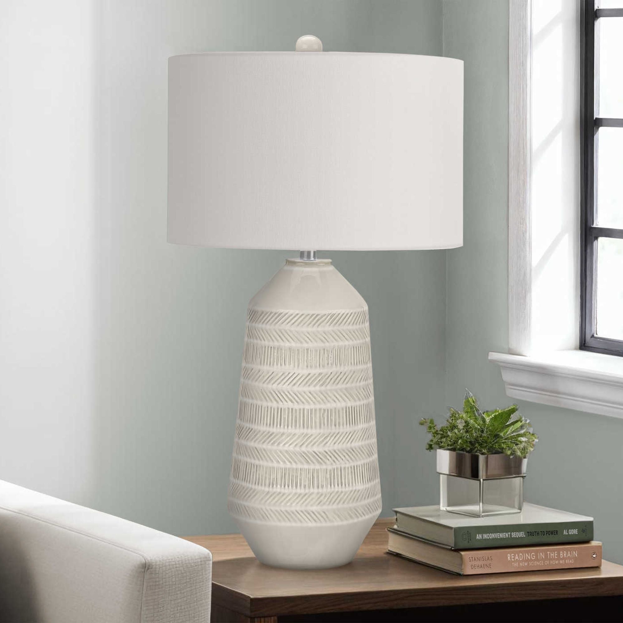 Cream ceramic table lamp with 33-inch height and modern design, from Monarch Specialties, featuring a sleek base and fabric shade.