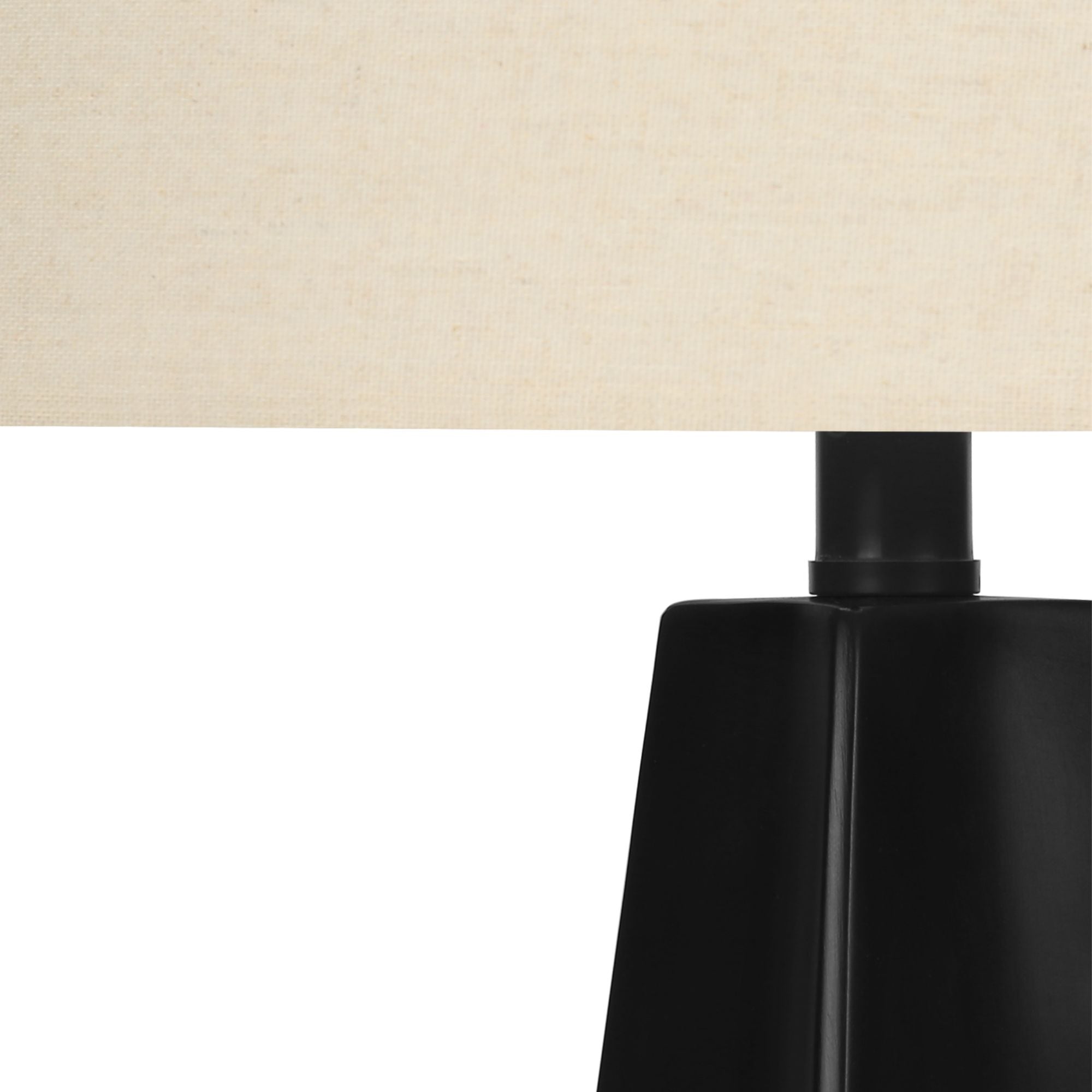 Modern black resin table lamp with beige fabric shade, 27 inches tall, by Monarch Specialties, shown with a sleek design and decorative base.