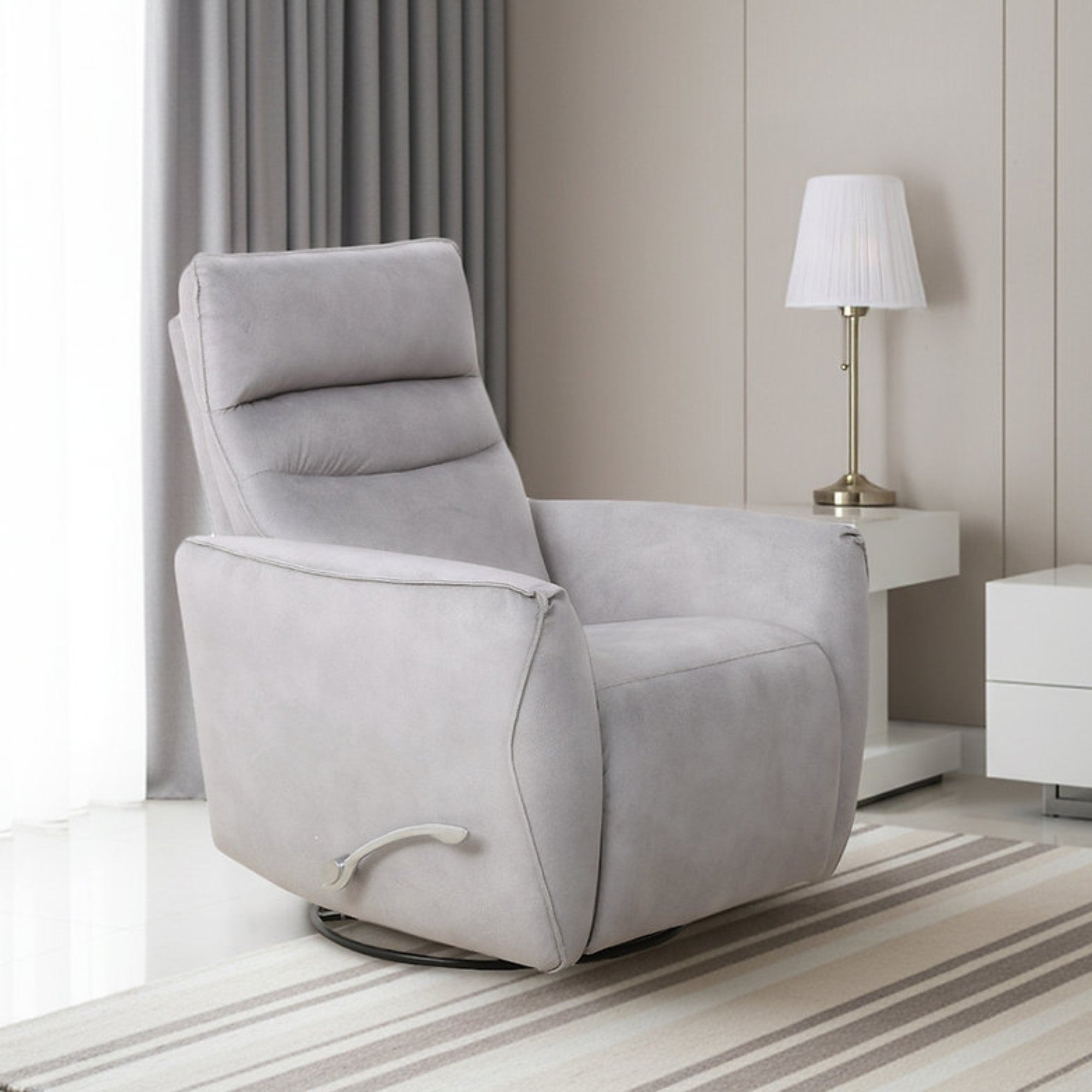Light grey IFF Arlo rocker recliner chair with cushioned back and armrests, designed for comfort and relaxation.