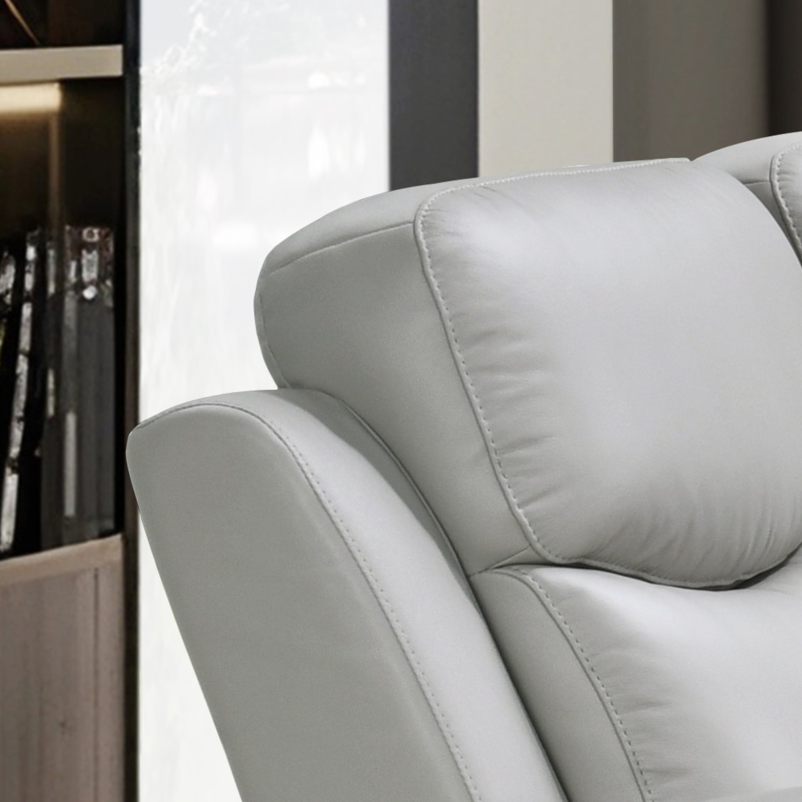 Light grey Axton Luxe leather power recliner sofa by IFF, showcasing plush cushioning and modern reclining design.