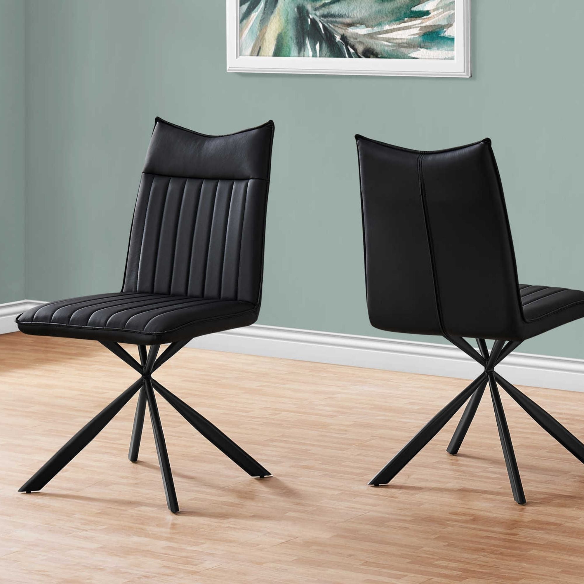 Set of two black leather-look dining chairs with starburst metal bases by Monarch Specialties, showcasing modern, stylish seating.