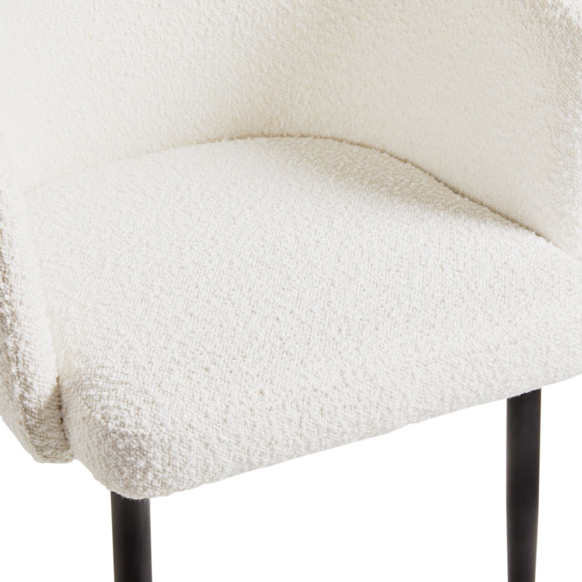 White bouclé Jordan dining chair by Xcella with sleek modern design, featuring plush upholstery and wooden legs.