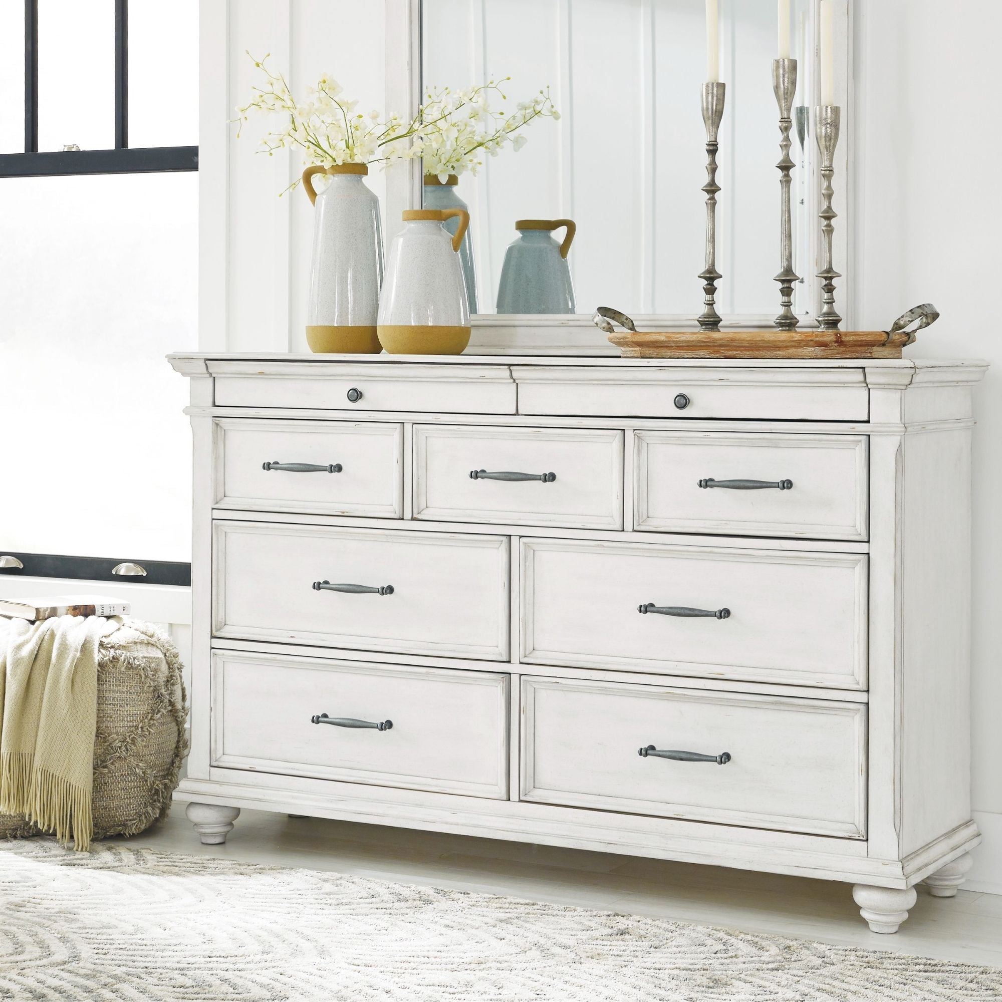 White Kanwyn dresser by Signature Ashley with sleek drawers and modern design, shown in a contemporary bedroom setting.