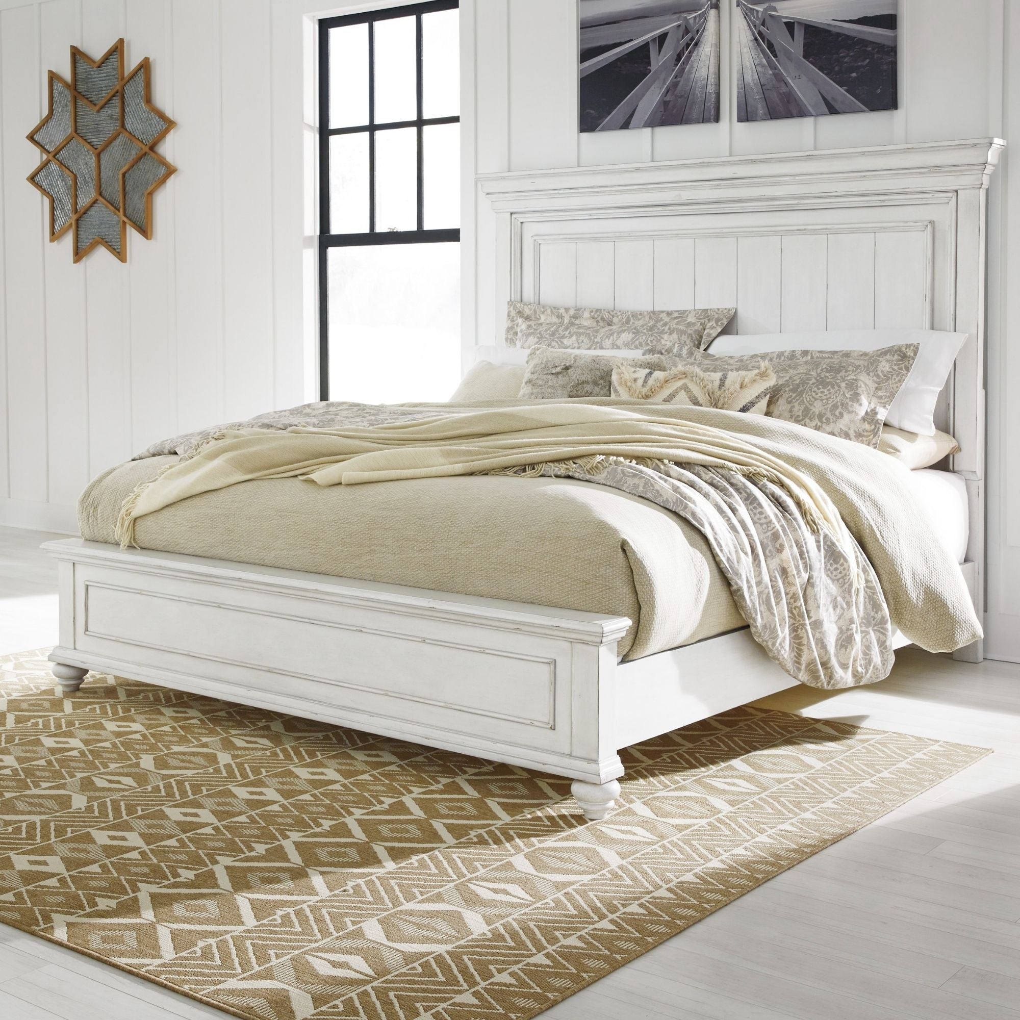 White Kanwyn panel bed by Signature Ashley with a classic headboard and clean lines, shown in a modern bedroom setting.