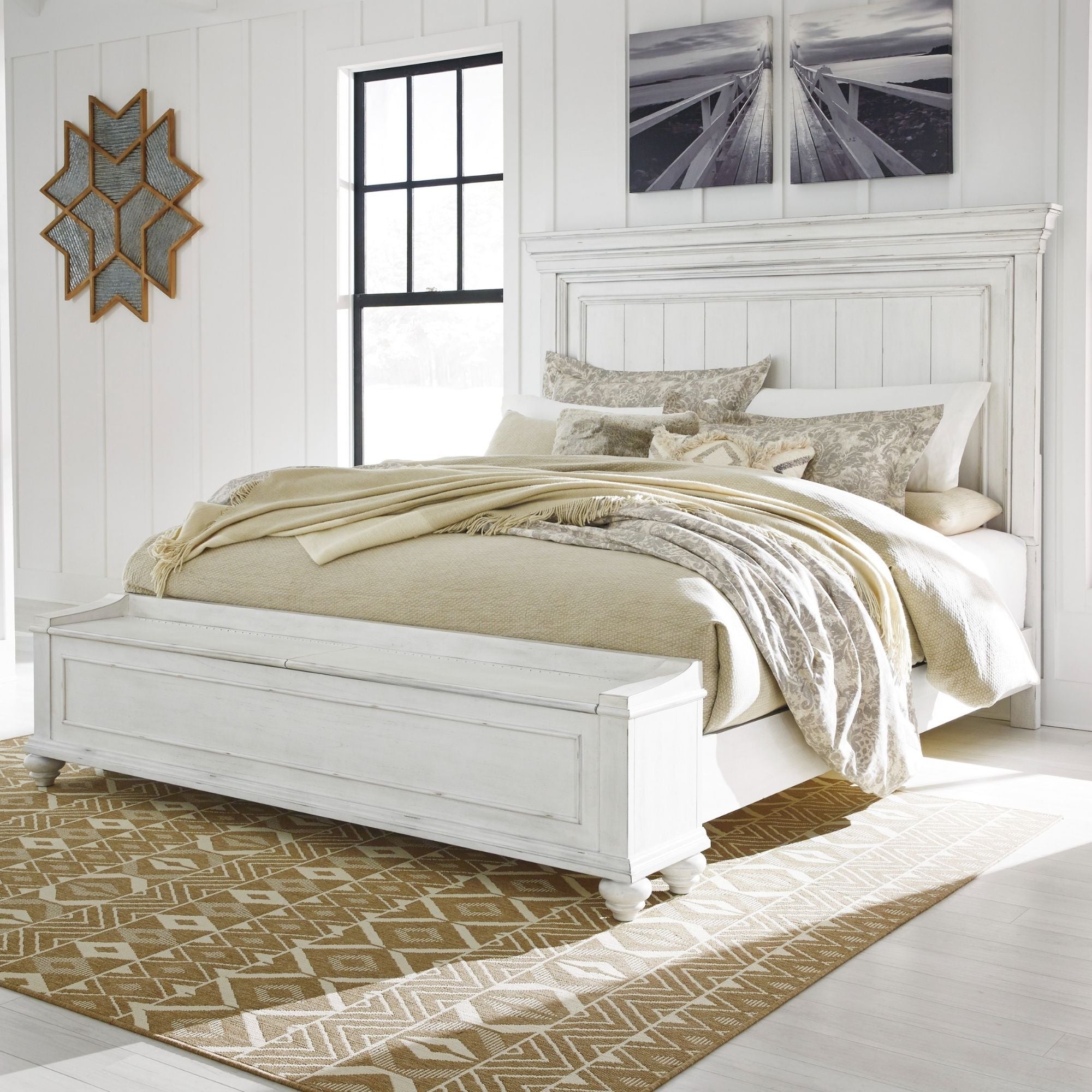 White Kanwyn panel bed from Signature Ashley with built-in storage bench, showcasing a modern bedroom furniture set.