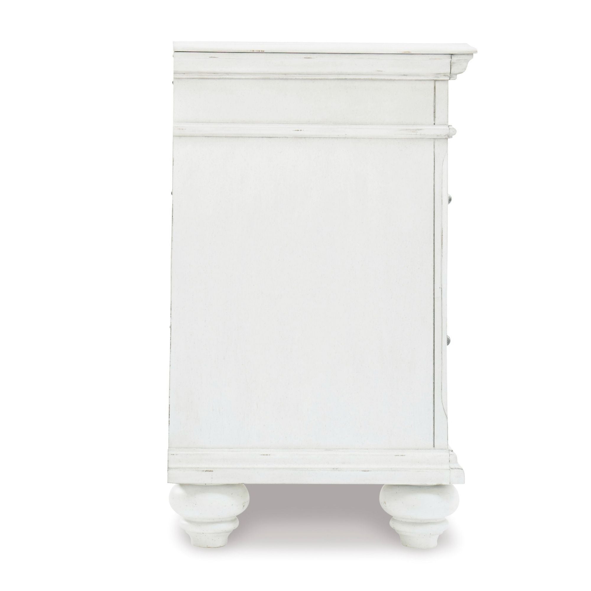 Signature Ashley Kanwyn three-drawer nightstand with wood finish, featuring sleek drawer handles and a modern bedroom setup.
