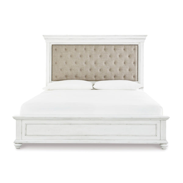 White Kanwyn Upholstered Panel Bed by Signature Ashley, showcasing the elegant headboard and modern design in a bedroom setting.