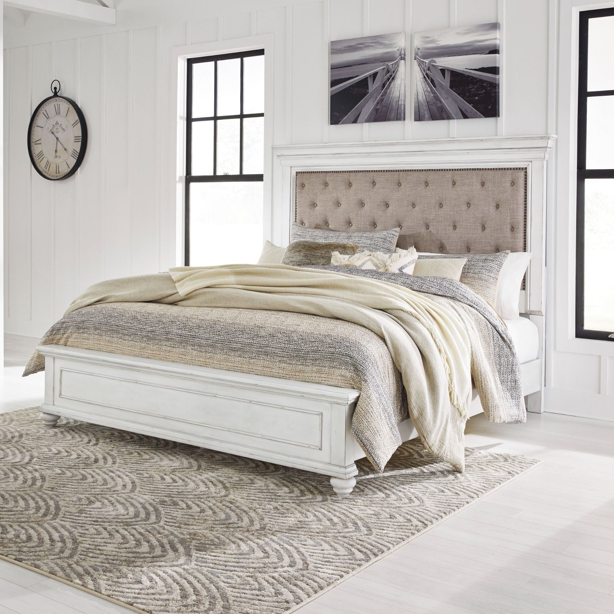 White upholstered panel bed from the Kanwyn collection by Signature Ashley, showcasing a stylish, padded headboard and clean design.
