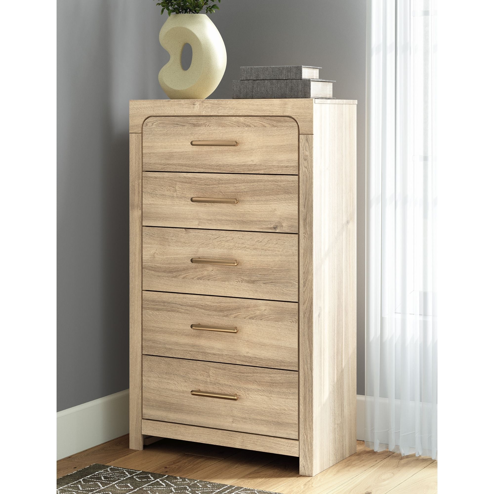 Tan Kinlanni five-drawer chest by Signature Ashley, showcasing a stylish bedroom storage piece with sleek drawer handles.
