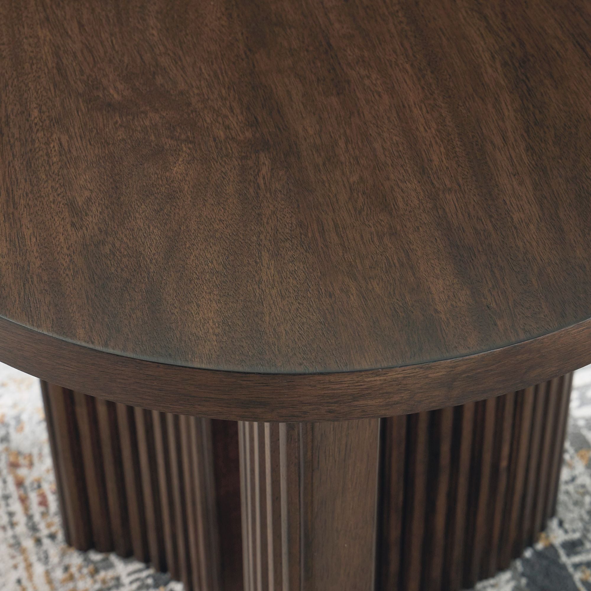 Signature Design by Ashley Korestone round end table with wooden top and metal legs, ideal for living room or bedroom decor.