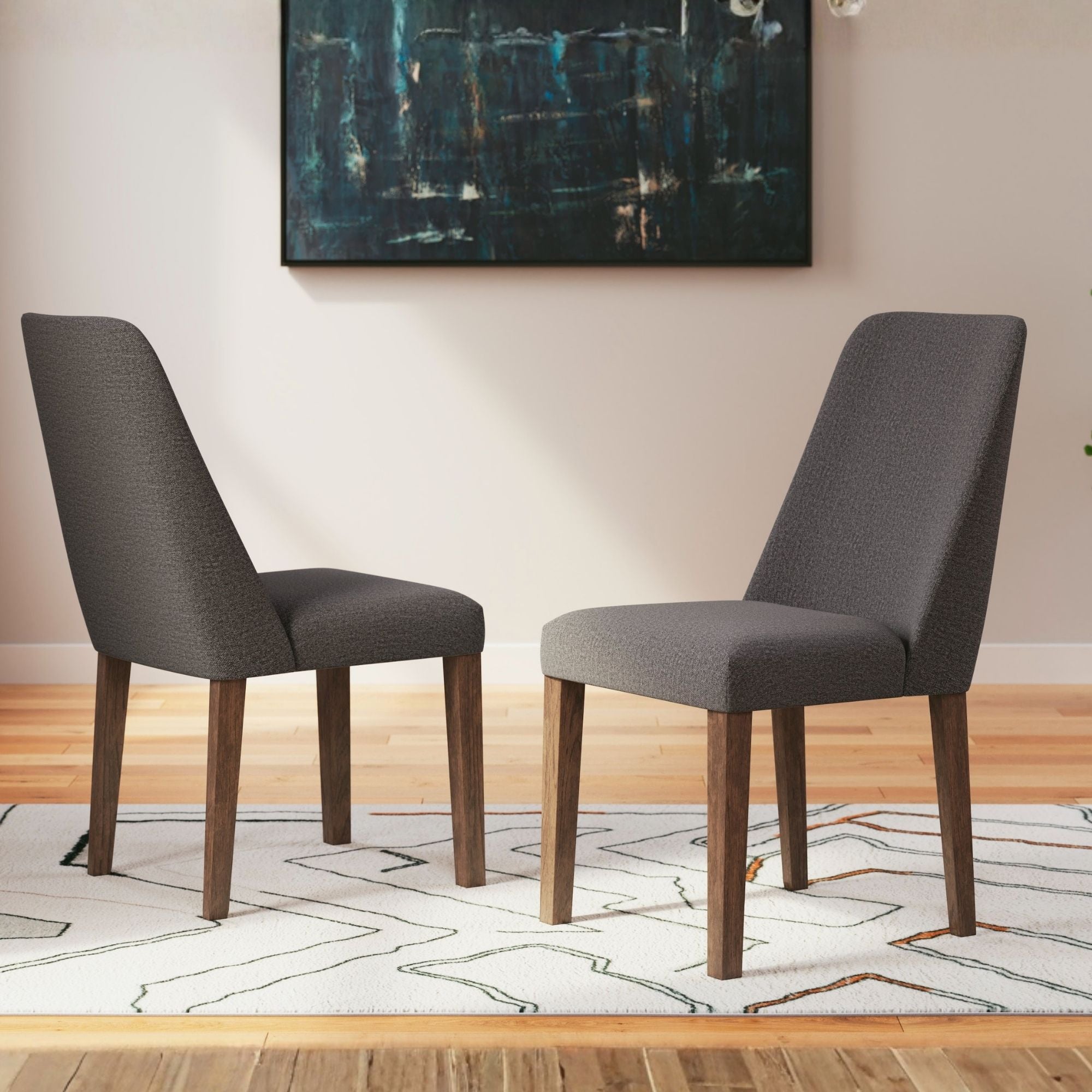 Set of two charcoal Lyncott dining UPH side chairs by Signature Ashley with upholstered seats and sleek modern design.
