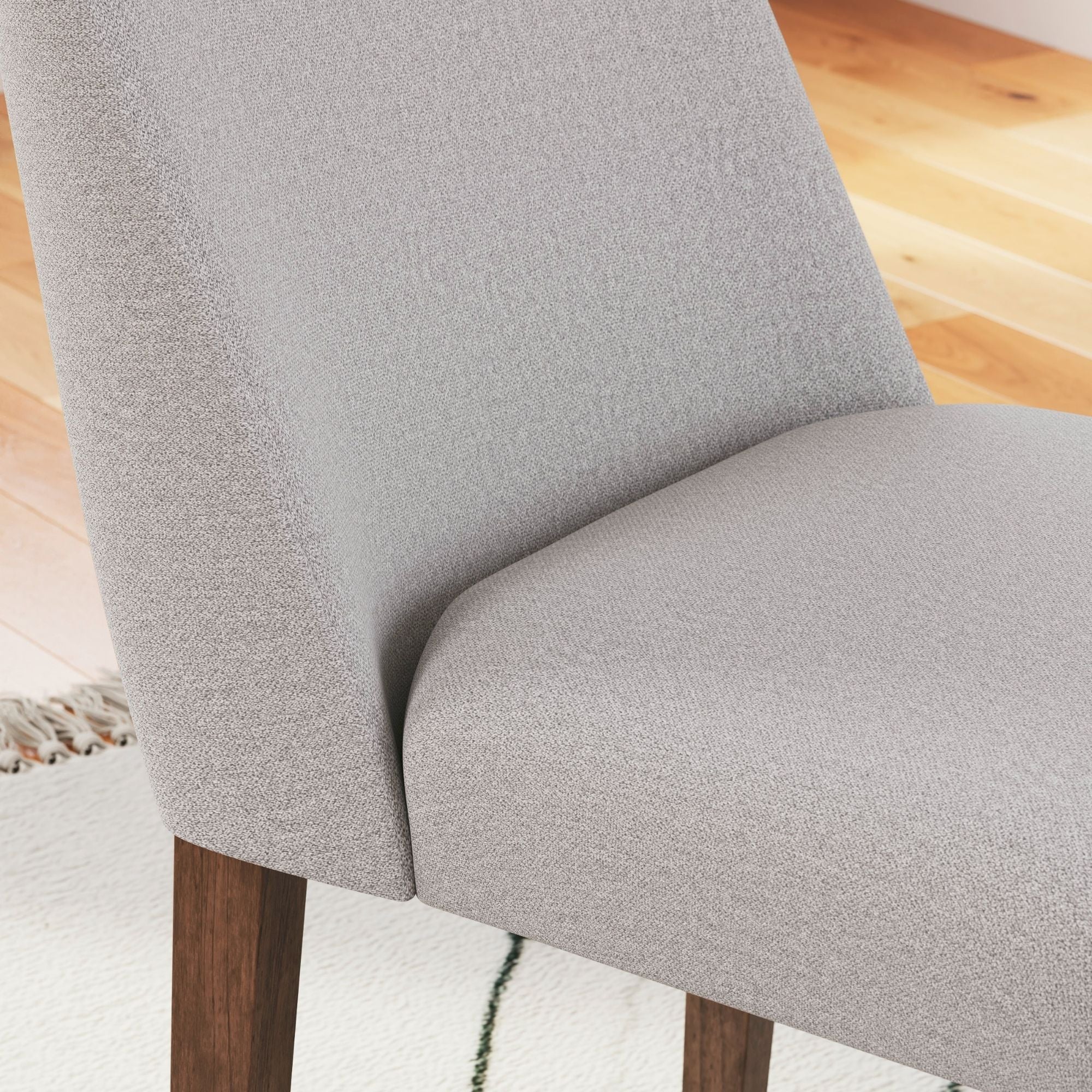 Light grey Lyncott collection dining room set with upholstered side chairs, crafted by Signature Ashley, arranged in a modern dining space.