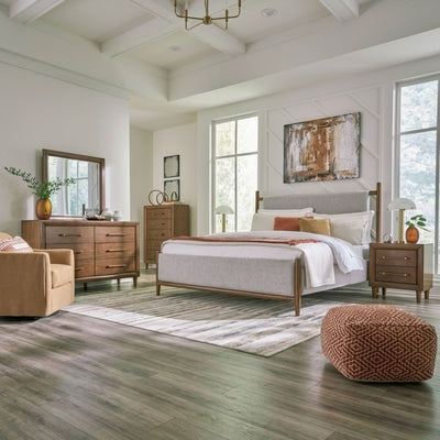 Signature Design by Ashley Lyncott upholstered panel bedroom set with bed, nightstands, and matching furniture in a modern style.