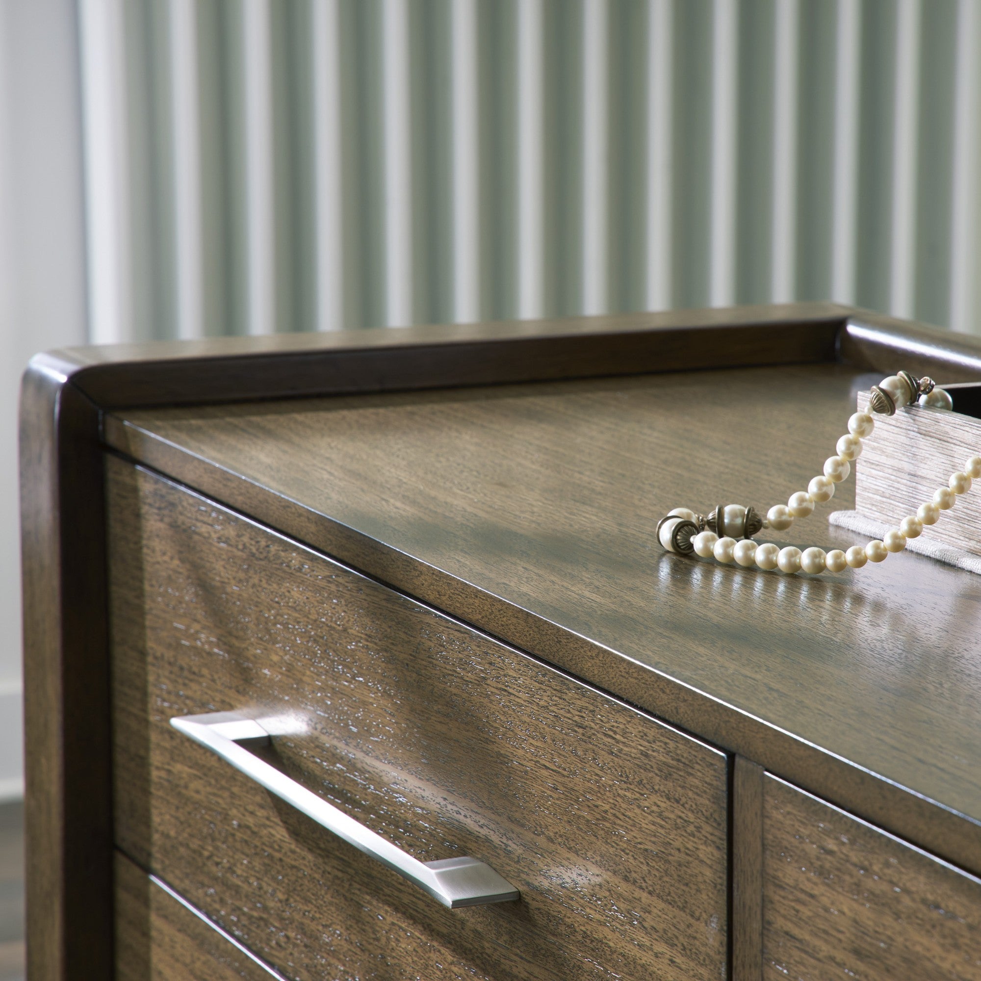 Signature Ashley Marxmore upholstered storage bed in a bedroom setting with a padded headboard and built-in storage drawers.