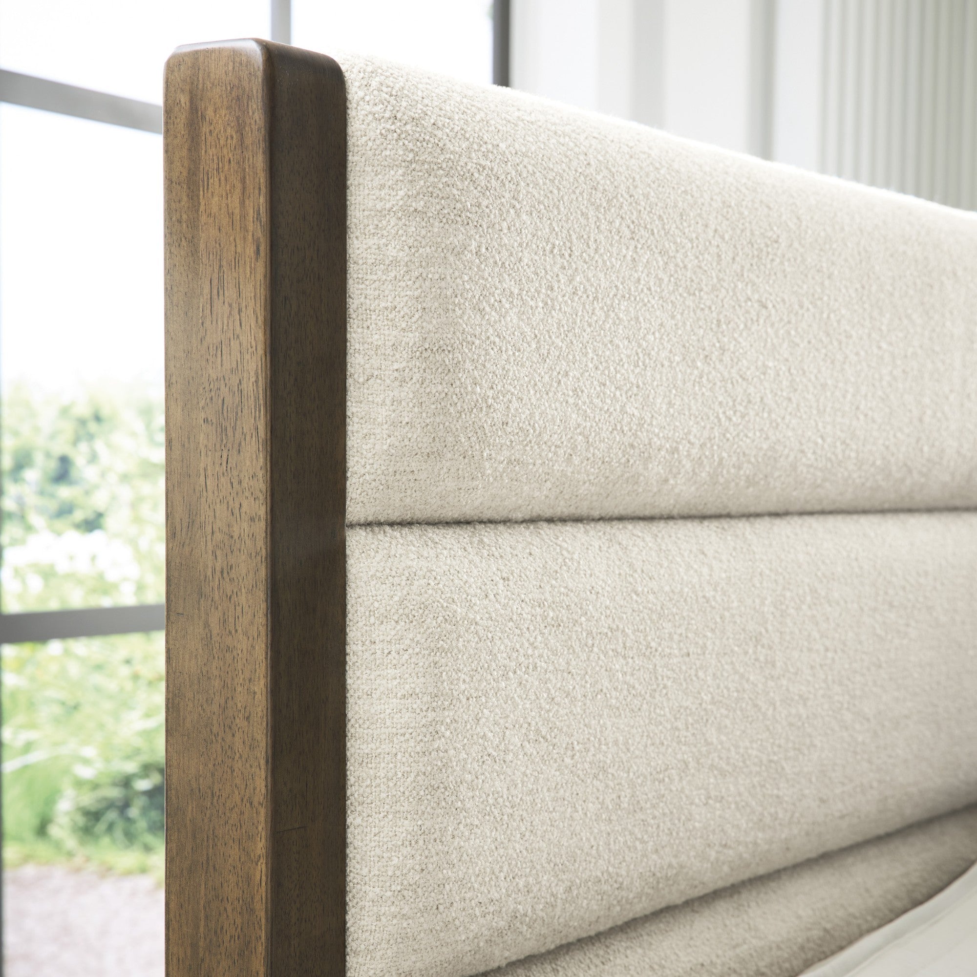 Signature Ashley Marxmore upholstered storage bed with plush fabric headboard and built-in storage drawers in a modern bedroom setting.