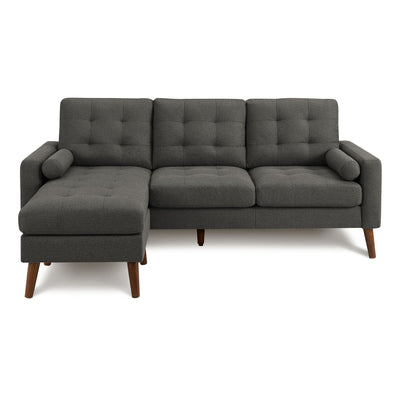 Dark grey Monarch Specialties Monroe reversible sectional sofa with L-shaped configuration and plush cushions, shown in a modern living room.