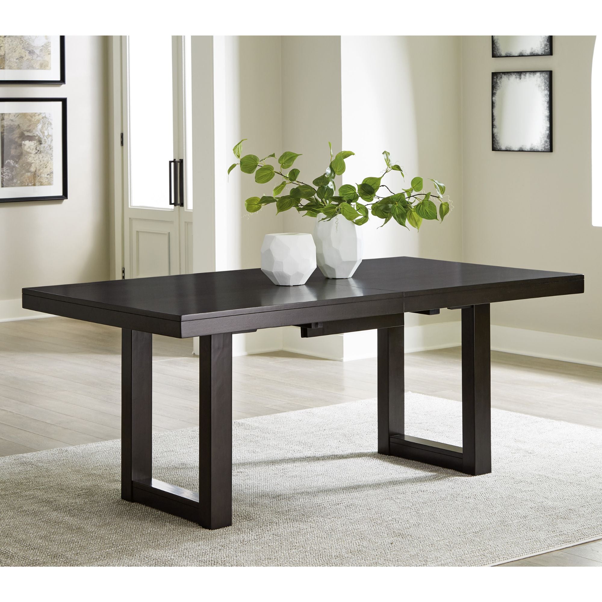 Neymorton dining extension table by Signature Ashley, showcasing a sturdy wood surface with extending leaves in a modern dining room setting.