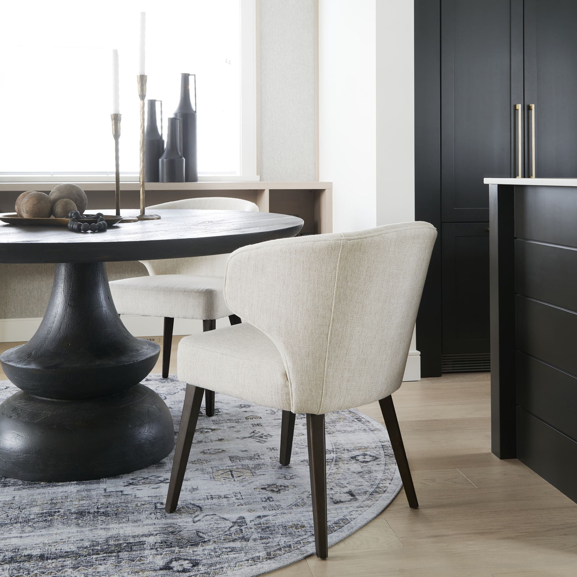 Dark brown Mercana Furniture Niles fabric dining chair with cushioned seat and backrest, showcasing a modern dining room setting.