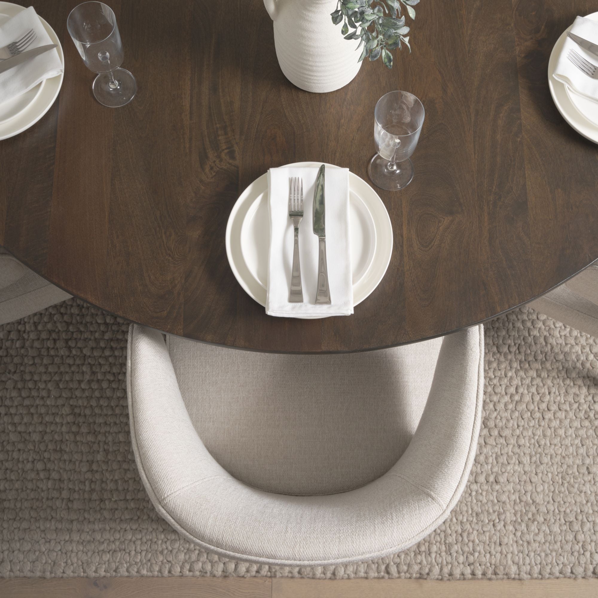 Dark brown Mercana Niles fabric dining chair with cushioned seat and backrest, showcasing elegant, modern design.