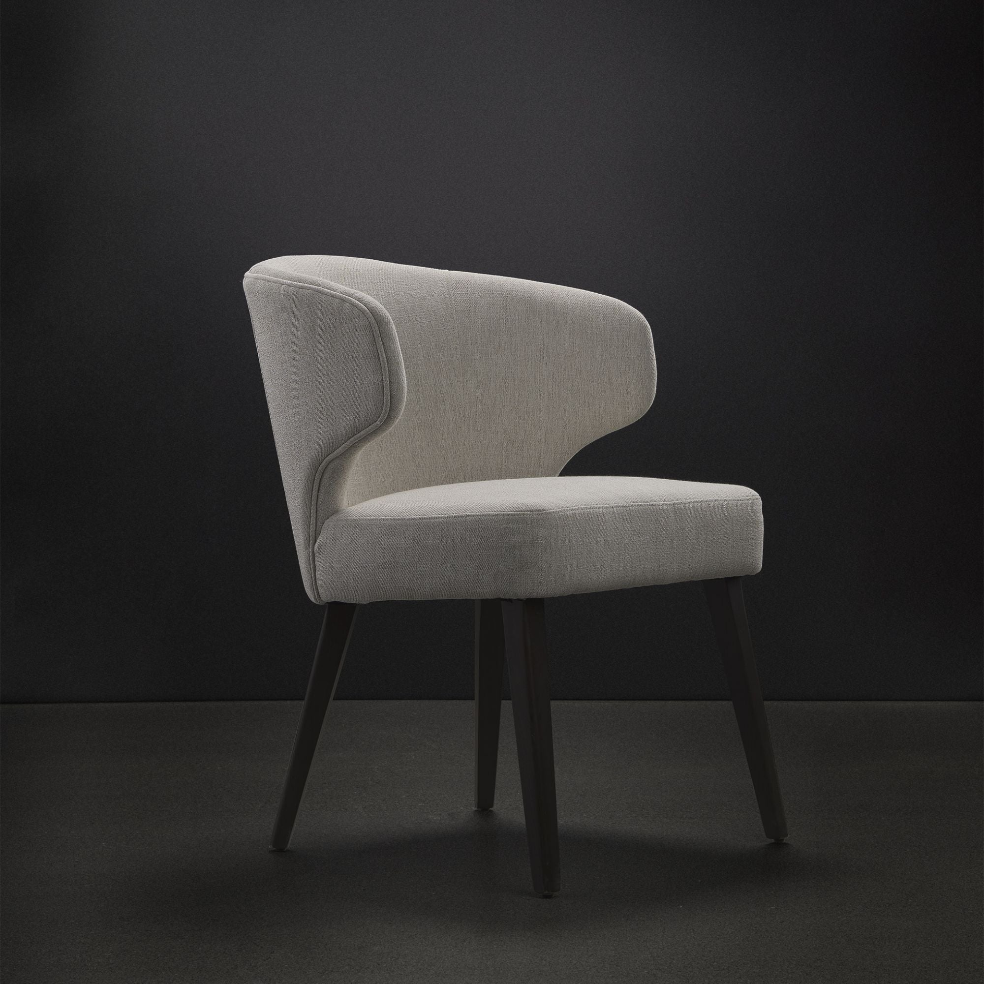 Dark brown Mercana Niles fabric dining chair with cushioned seat and backrest, showcasing a modern, comfortable dining room style.