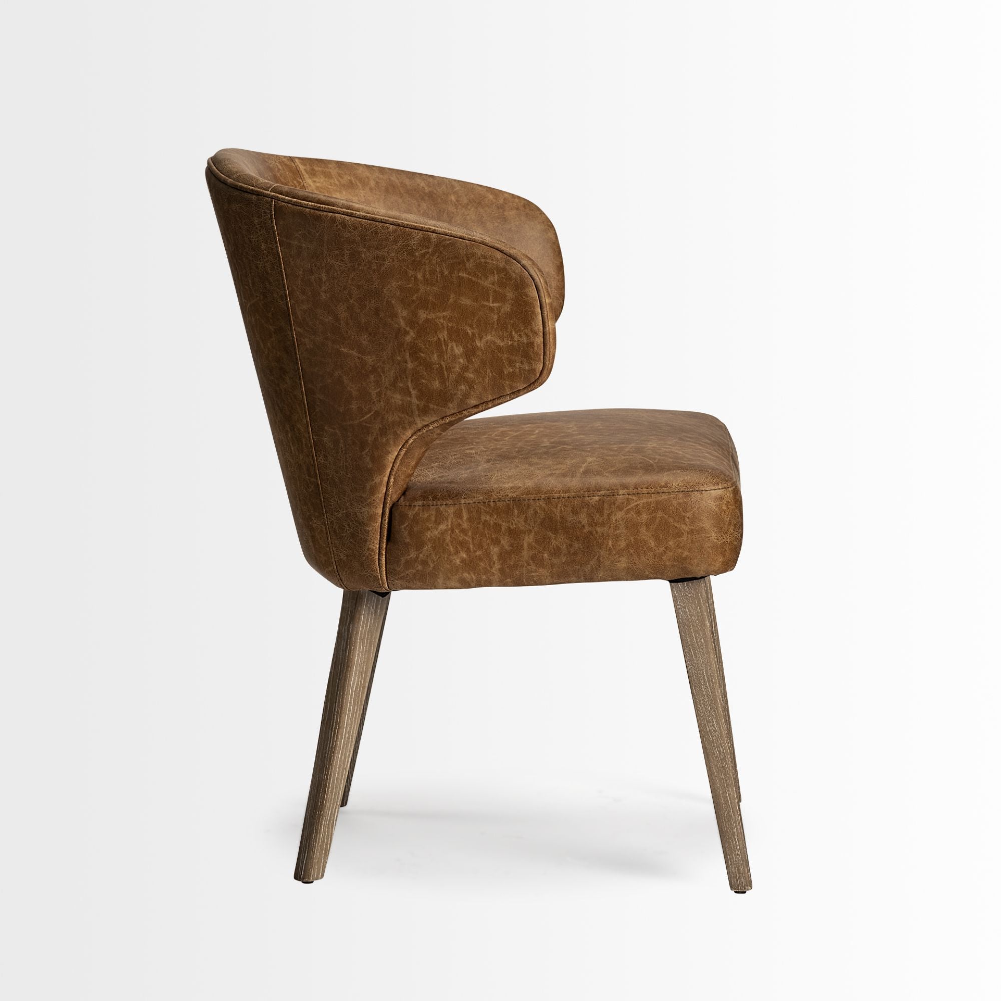 Mercana Furniture Niles faux leather dining chair with sleek design and cushioned seat, ideal for modern dining rooms.