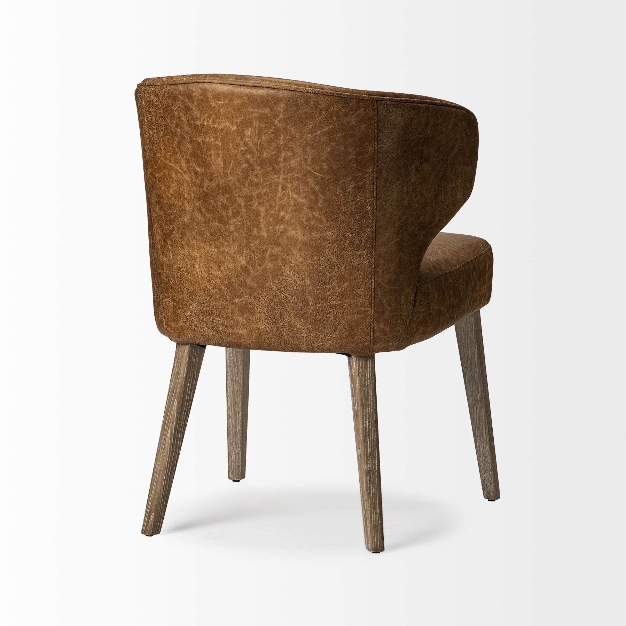 Mercana Furniture Niles faux leather dining chair with sleek wooden legs, modern design, and cushioned seat for comfortable dining.