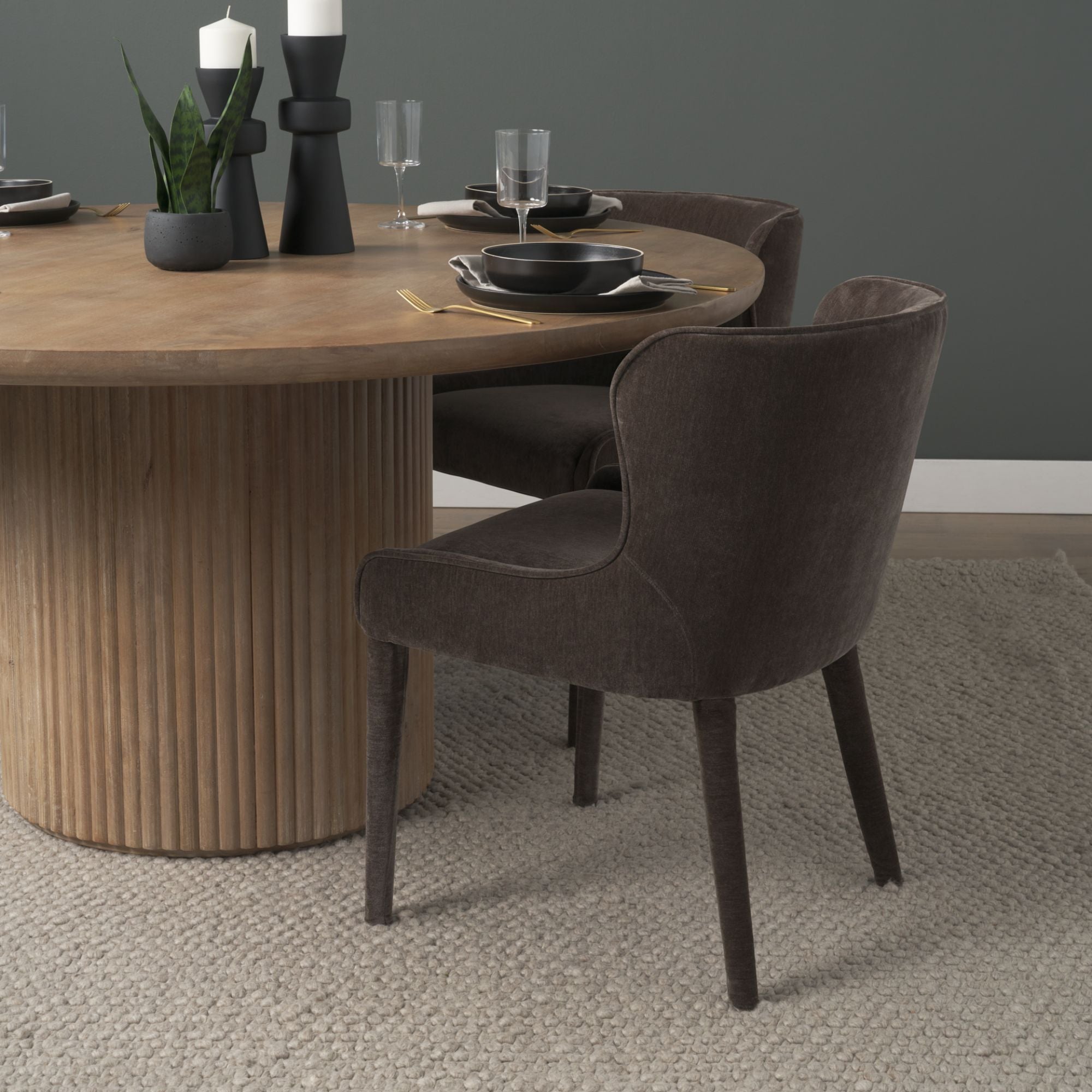 Mercana Furniture Nolan dining chair with cream chenille upholstery and modern design, shown in a charcoal setting.