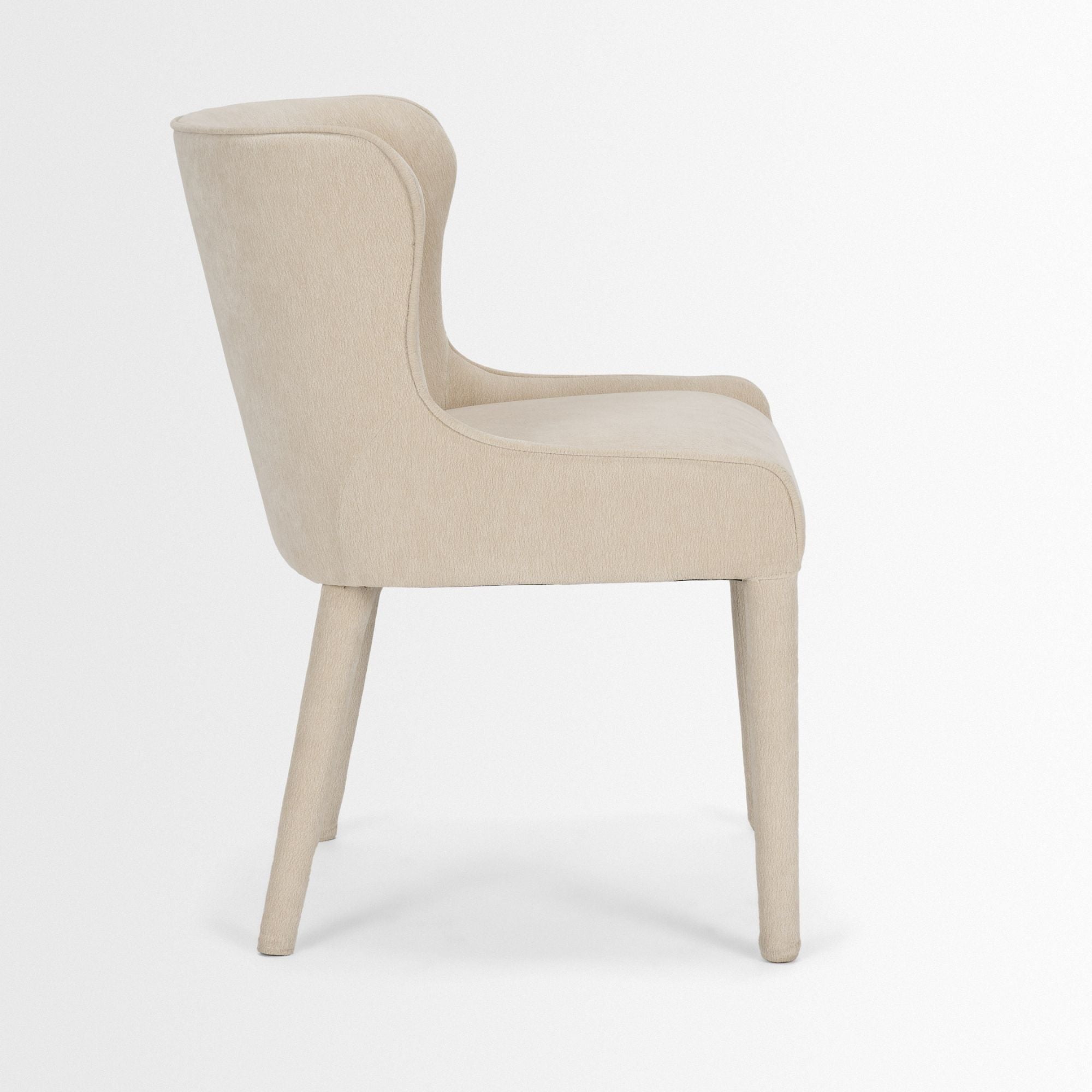 Mercana Furniture Nolan dining chair in plush cream chenille fabric, showcasing a modern design with wooden legs.