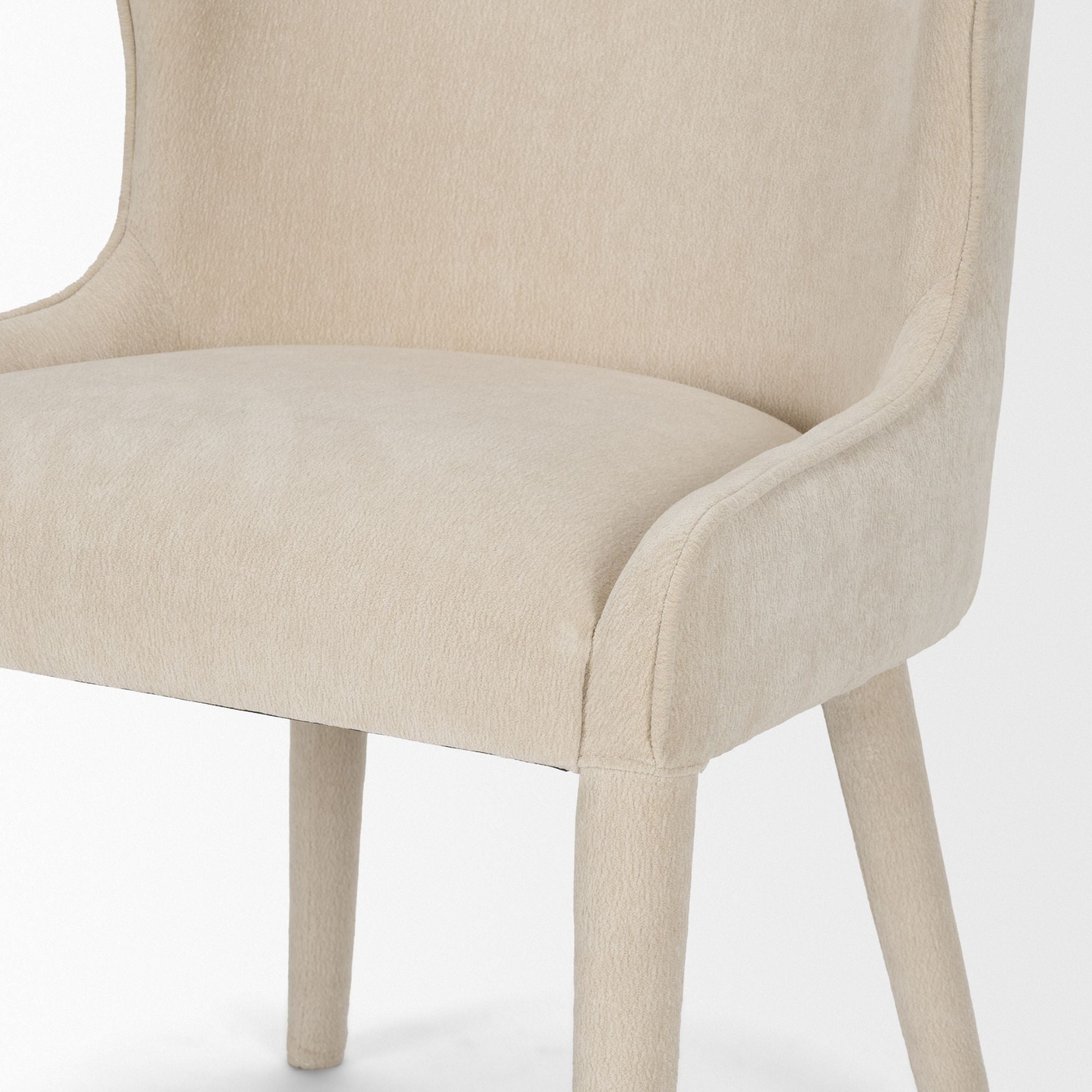 Cream chenille Nolan dining chair by Mercana Furniture with wooden legs, showcasing a plush, comfortable design for modern dining rooms.